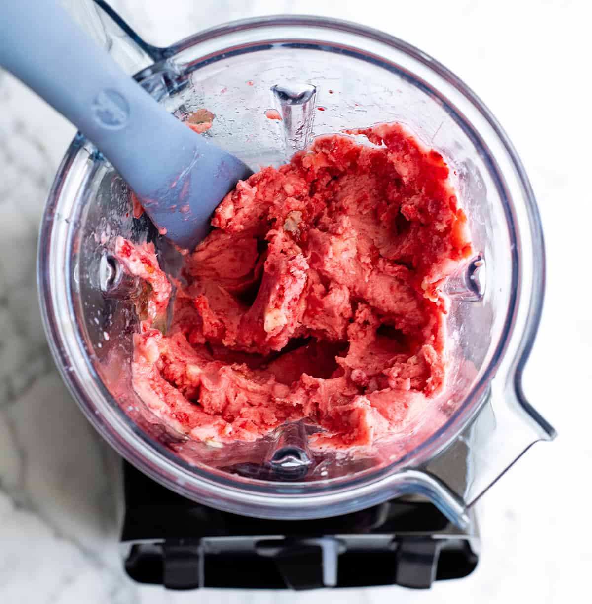 Learn how to make the BEST smoothie bowl with 5 ingredients in 5 minutes! Follow our step-by-step photos and video to make this easy and healthy smoothie bowl recipe with three different varieties (strawberry, acai, and pineapple spinach). Smoothie bowls make the best breakfast, brunch or snack, and you can save so much money making them at home! Paleo, dairy-free and vegan-friendly. overhead photo showing how to make a smoothie bowl in a Vitamix blender