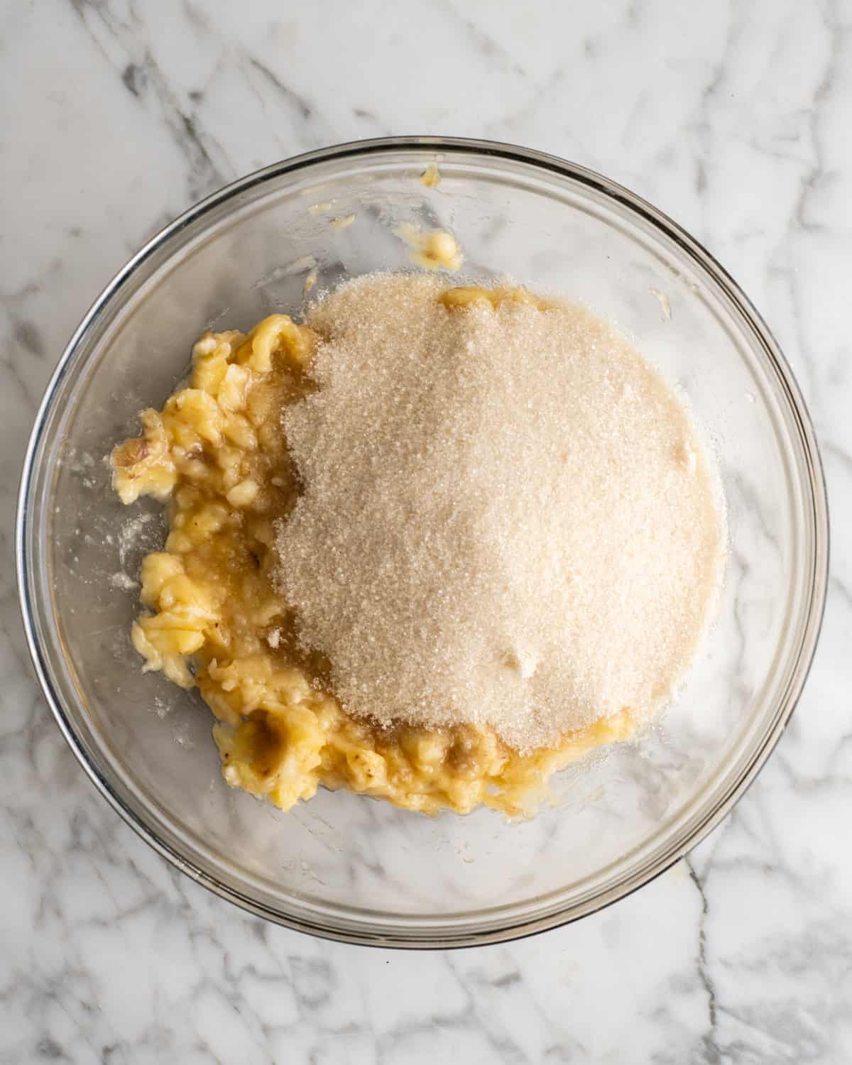 How to Make Banana Cake - sugar added to mashed bananas before stirring