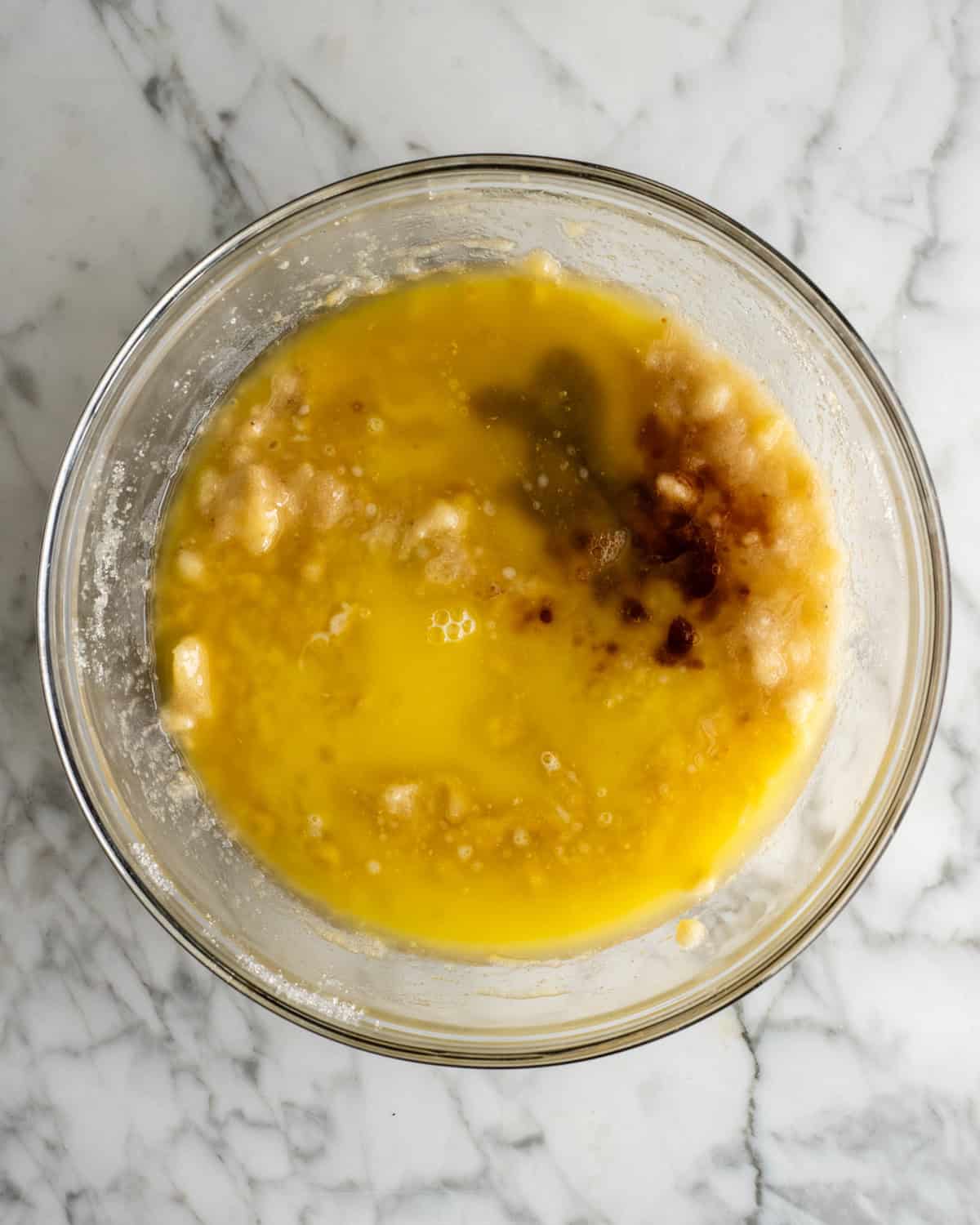 How to Make Banana Cake - vanilla and butter added to the sugar banana mixture before stirring