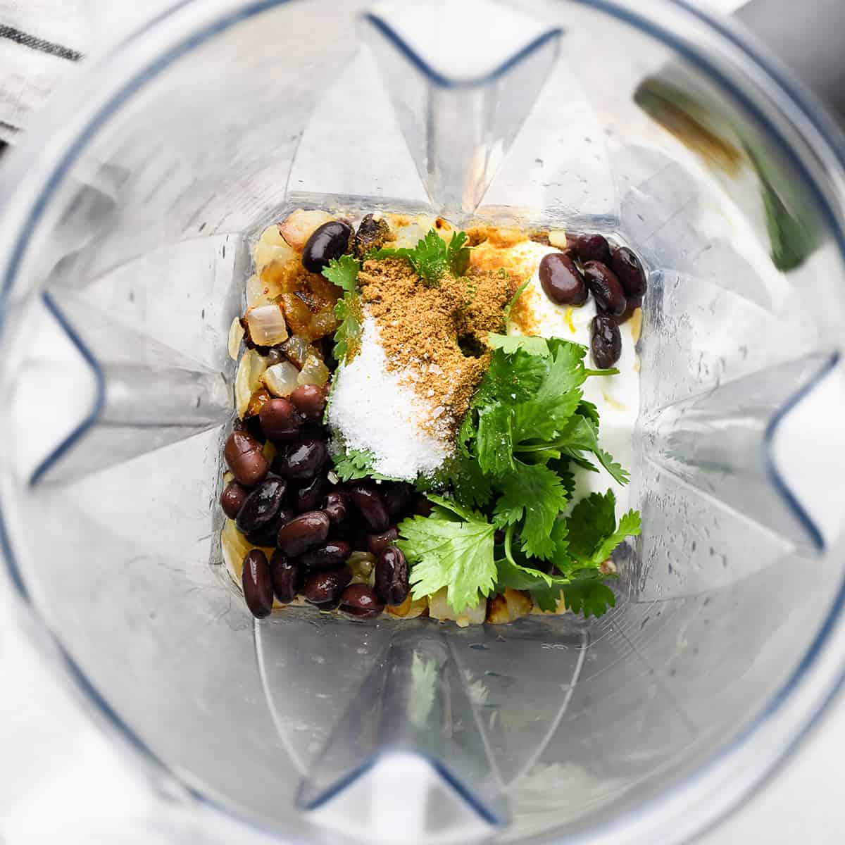 photo showing how to make black bean dip - ingredients in a Vitamix blender before blending