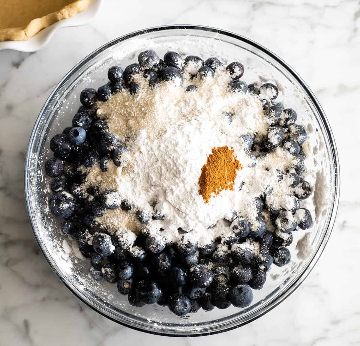 This is the best homemade Blueberry Pie Recipe you'll ever make! It's made from scratch with a fresh blueberry pie filling and NO cornstarch, and includes step-by-step instructions and photos! overhead view showing how to make blueberry pie filling