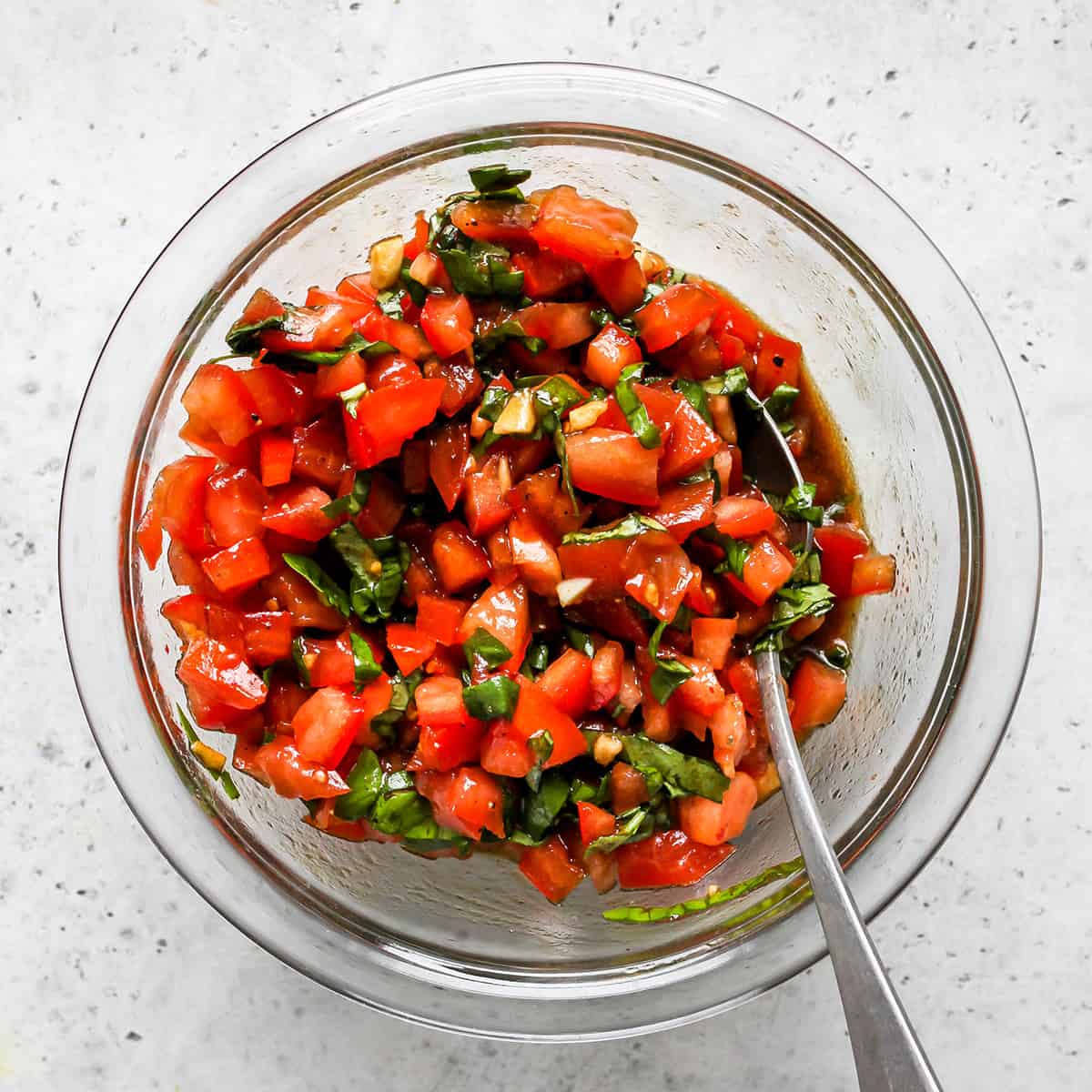 photo showing How to Make Bruschetta - mixing the ingredients together.