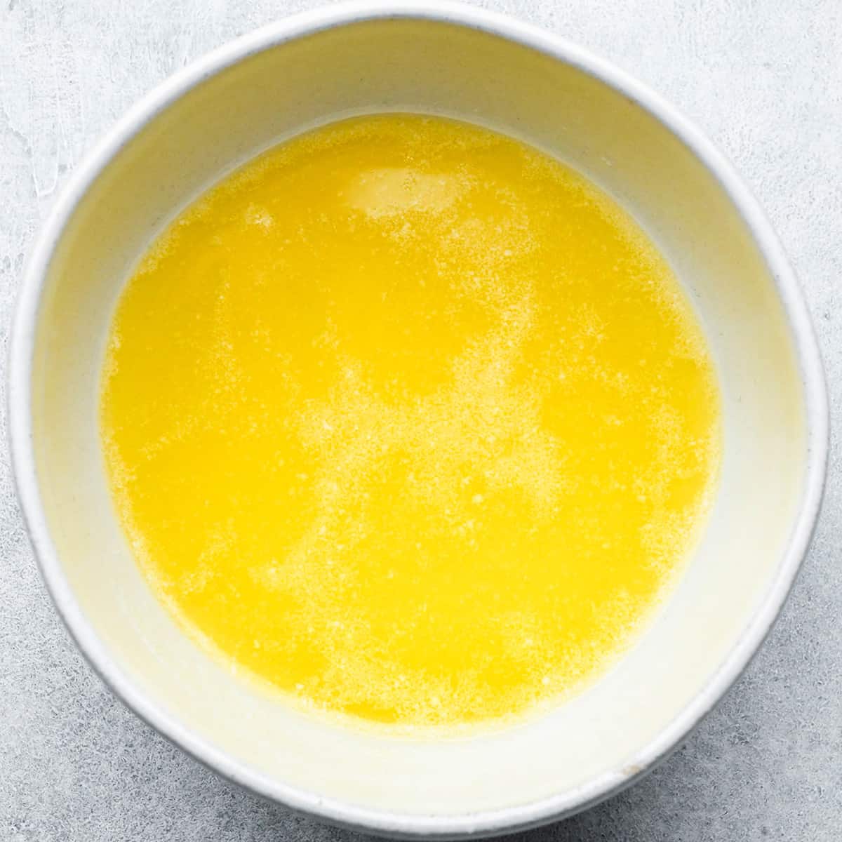 melted butter in a bowl to make buttered popcorn