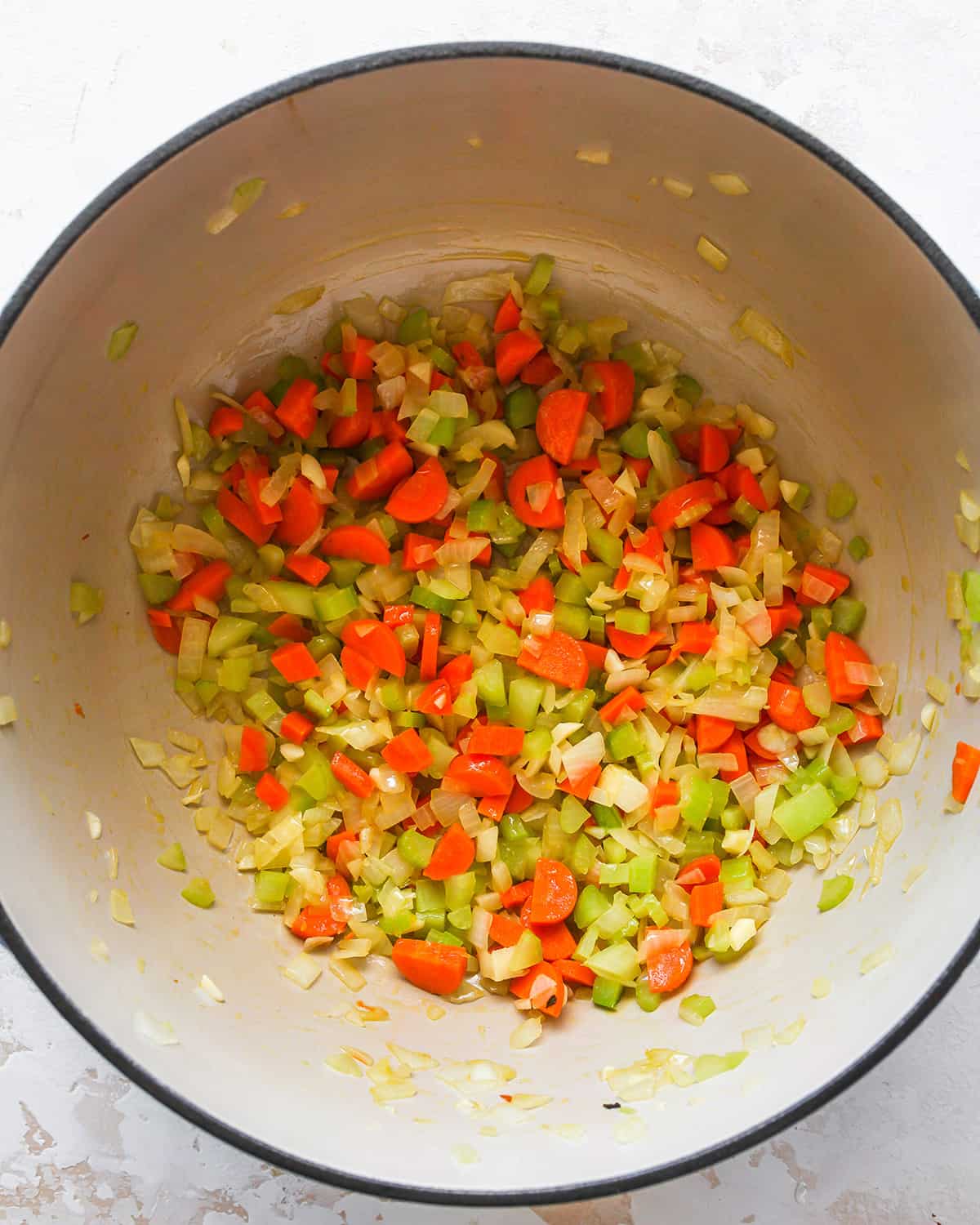 Vegetables and olive oil in a stockpot after cooking to make chicken noodle soup