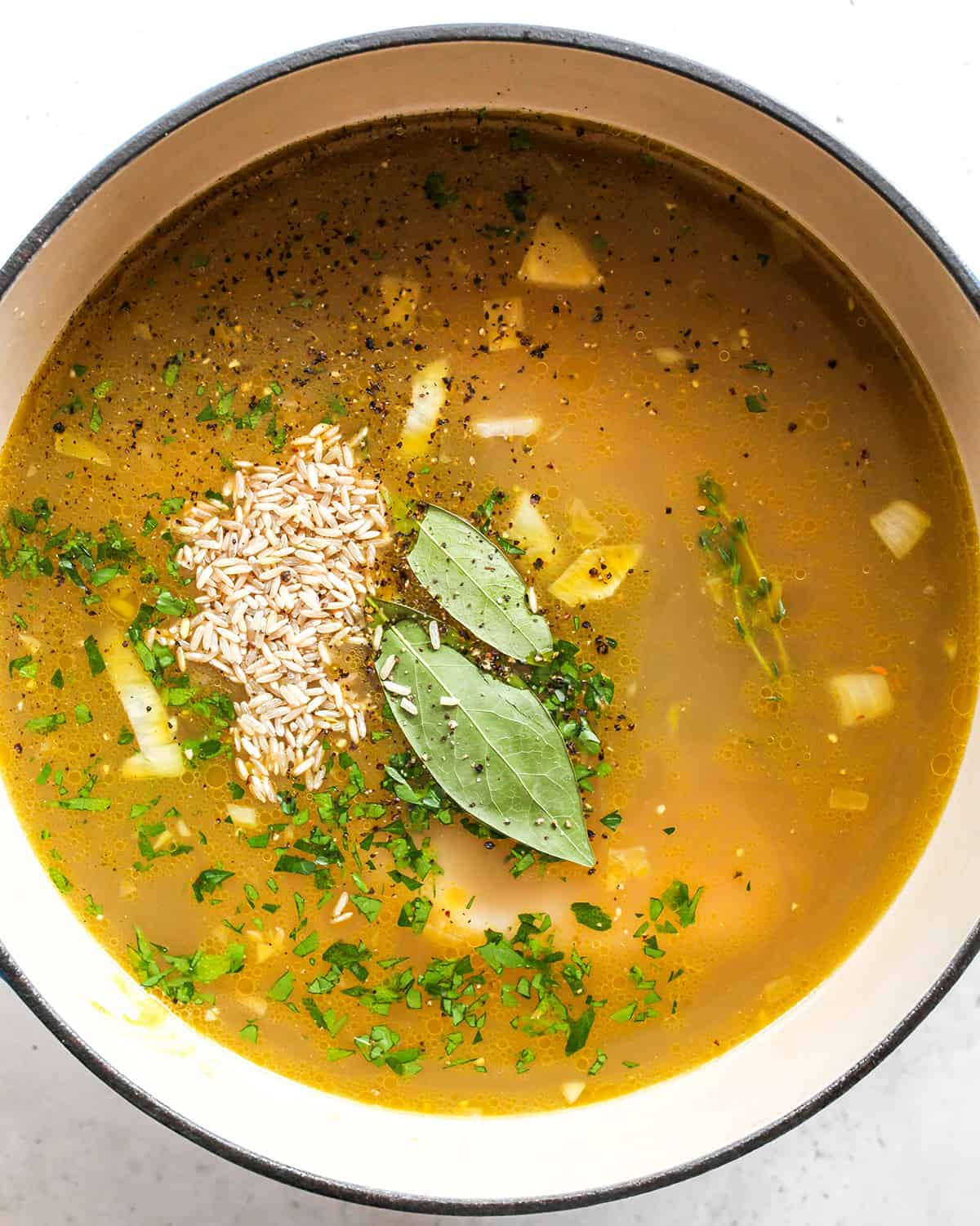 how to make Chicken Rice Soup - adding rice and herbs