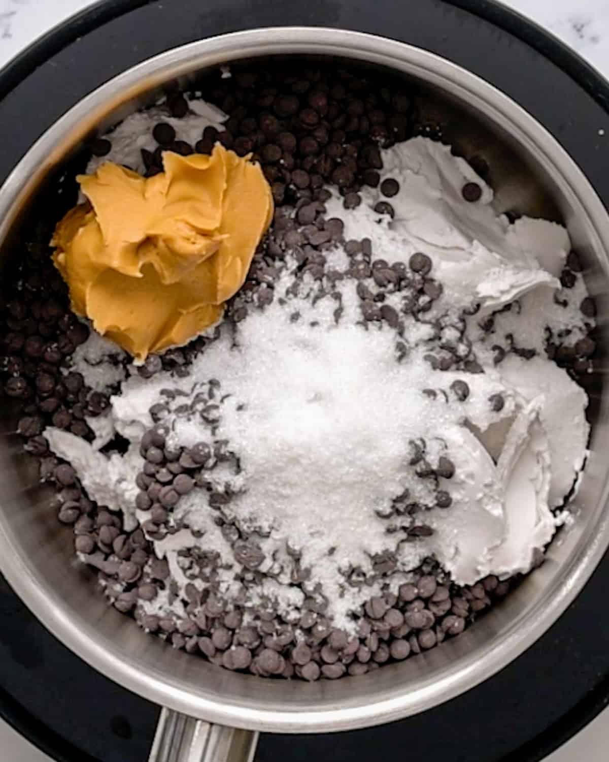 Chocolate Peanut Butter Fondue ingredients in a pot before melting and stirring