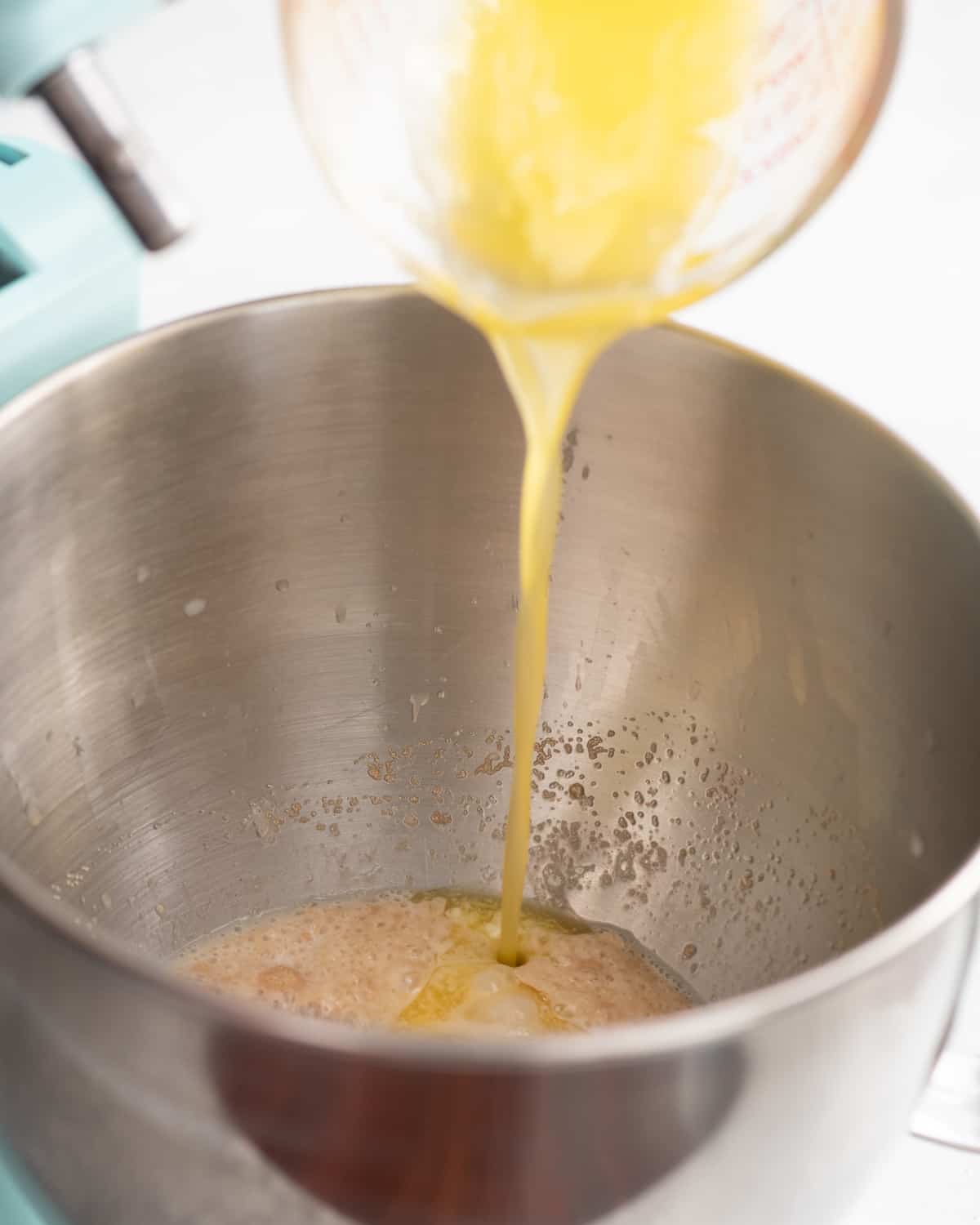 butter being added to cinnamon roll dough