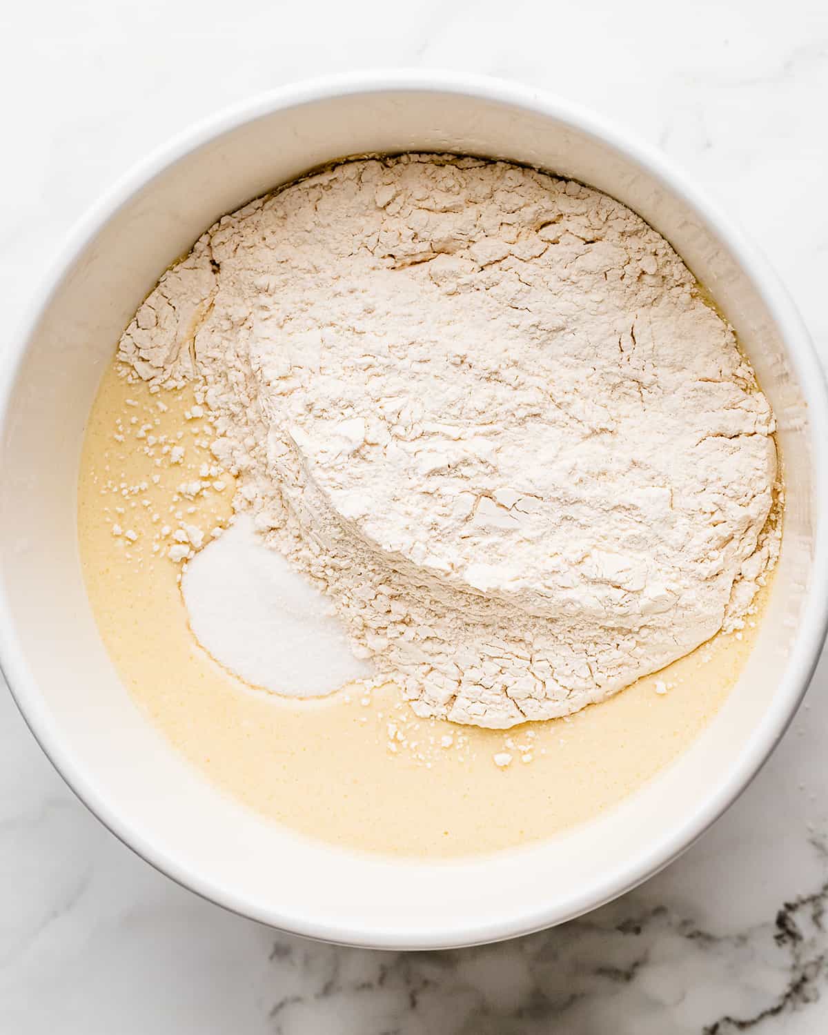 how to make coconut cake- adding dry ingredients to the wet ingredients