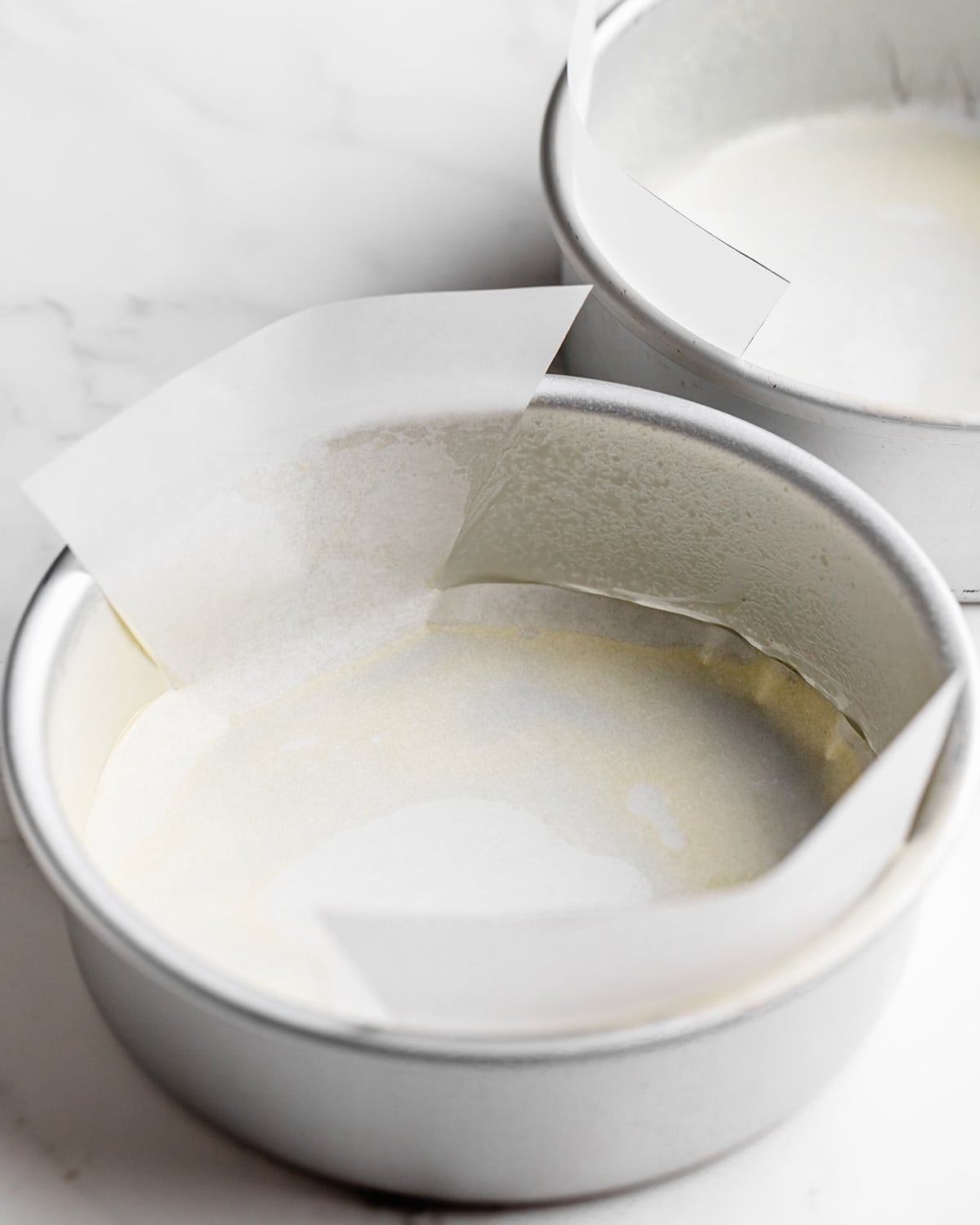 two pans lined and greased to make Coconut Cake