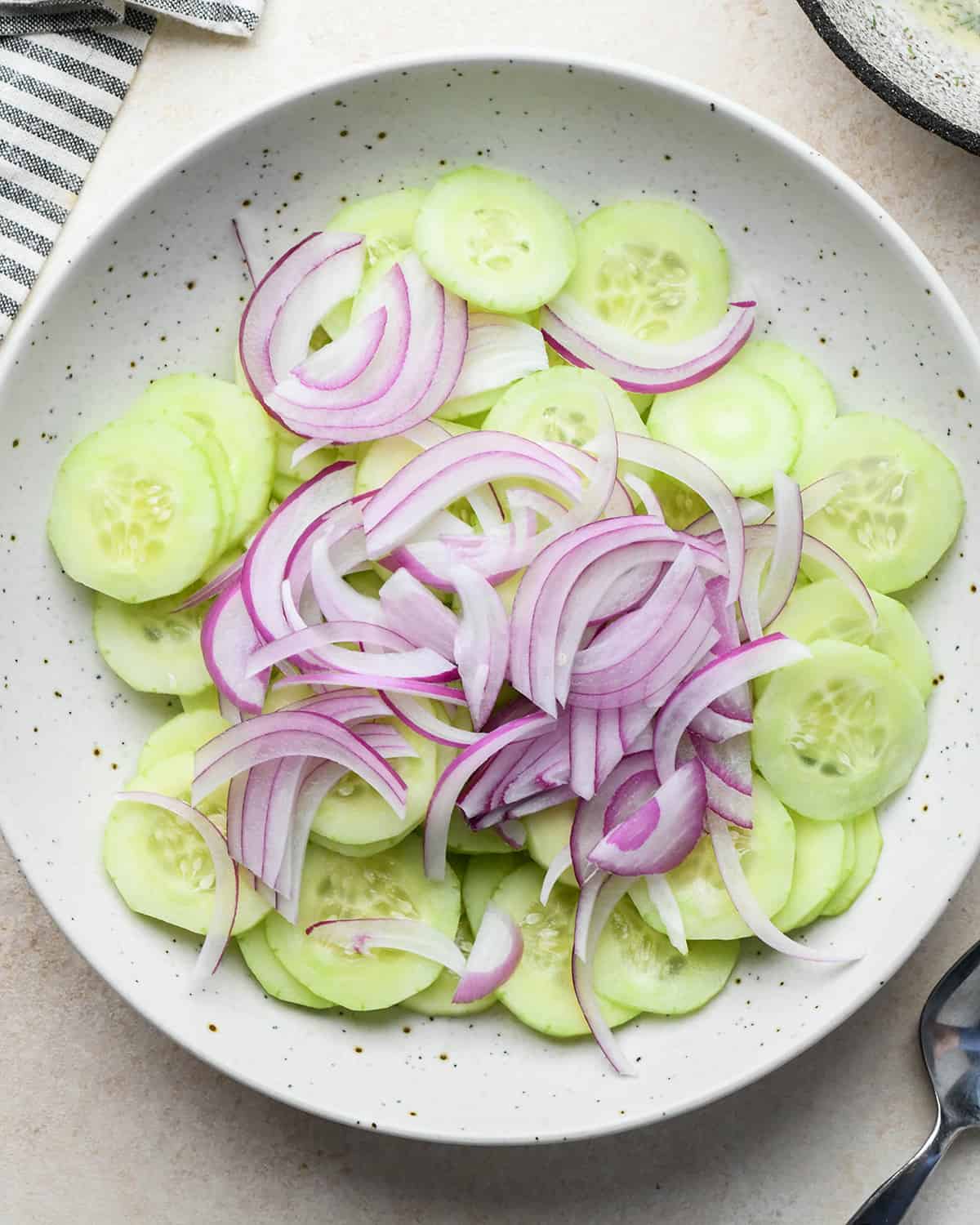 How to make Cucumber Salad - cucumbers and onions in a bowl
