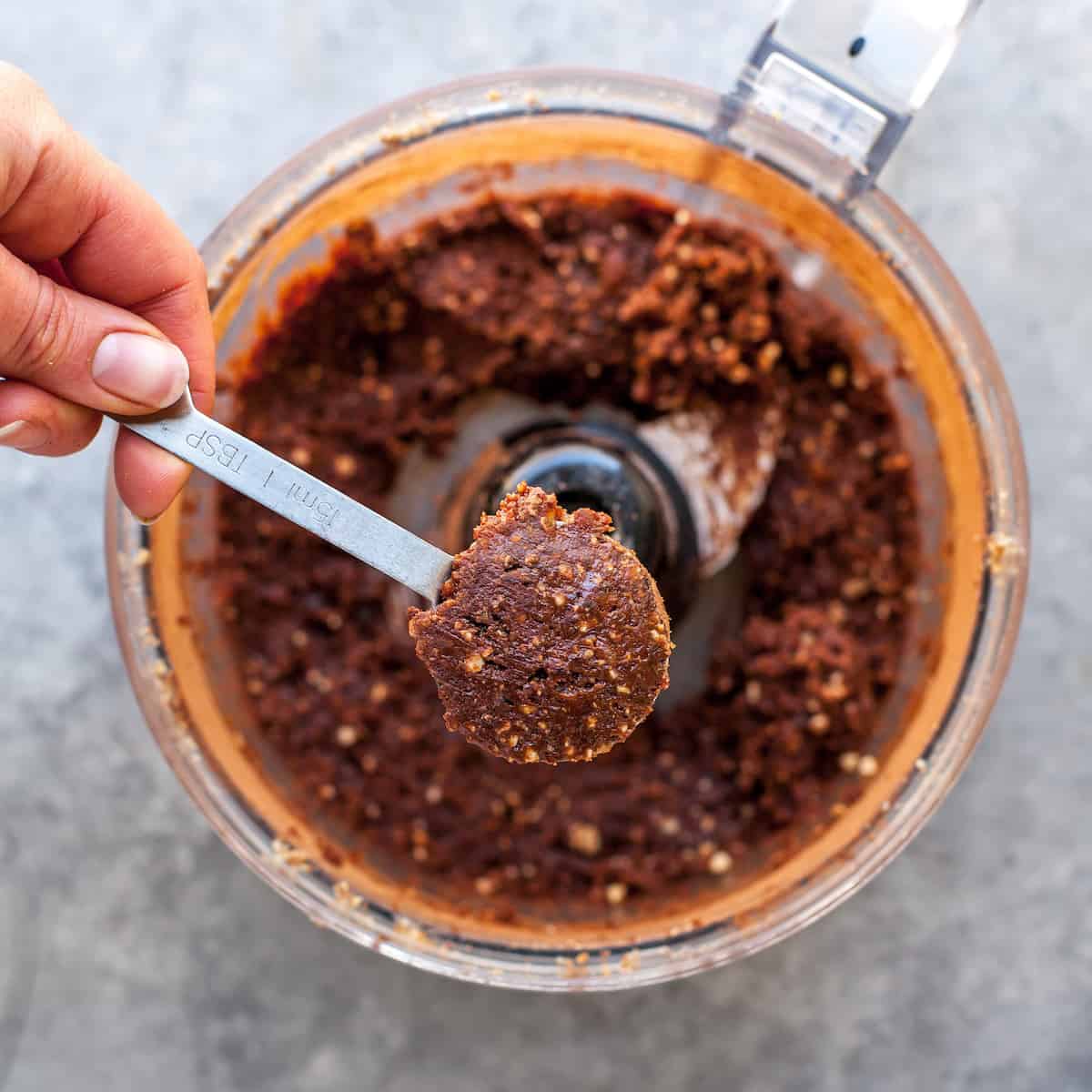 No-Bake Chocolate Date Energy Balls Recipe! These healthy energy balls are made in 5 minutes with 8 ingredients and they taste brownie bites! They are vegan, Paleo gluten-free and have no refined sugar, but you'd never know it! They're also freezer-friendly! #energyballs #energybites #vegan #paleo #snack #glutenfree #joyfoodsunshine overhead photo showing measuring out date energy balls
