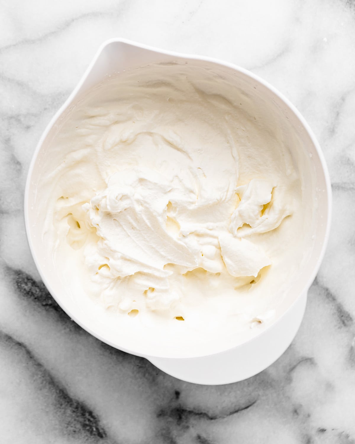 whipping cream in a bowl after being whipped