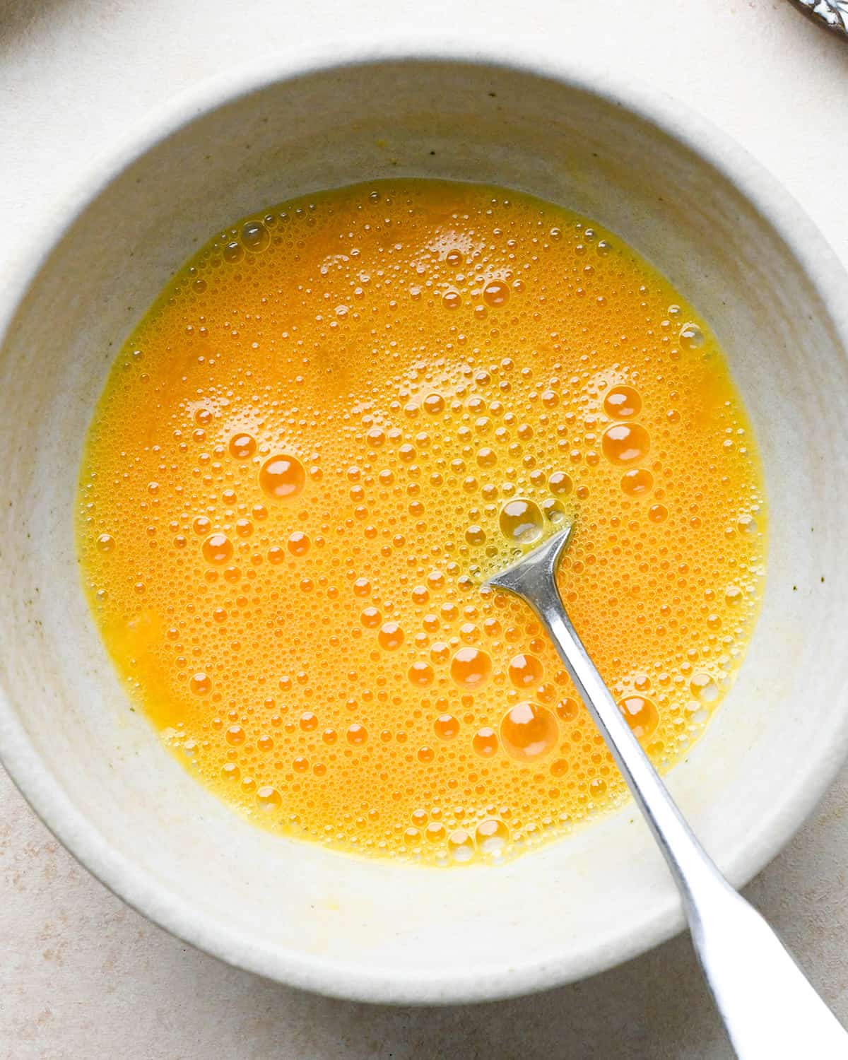 two eggs and salt in a bowl before beating