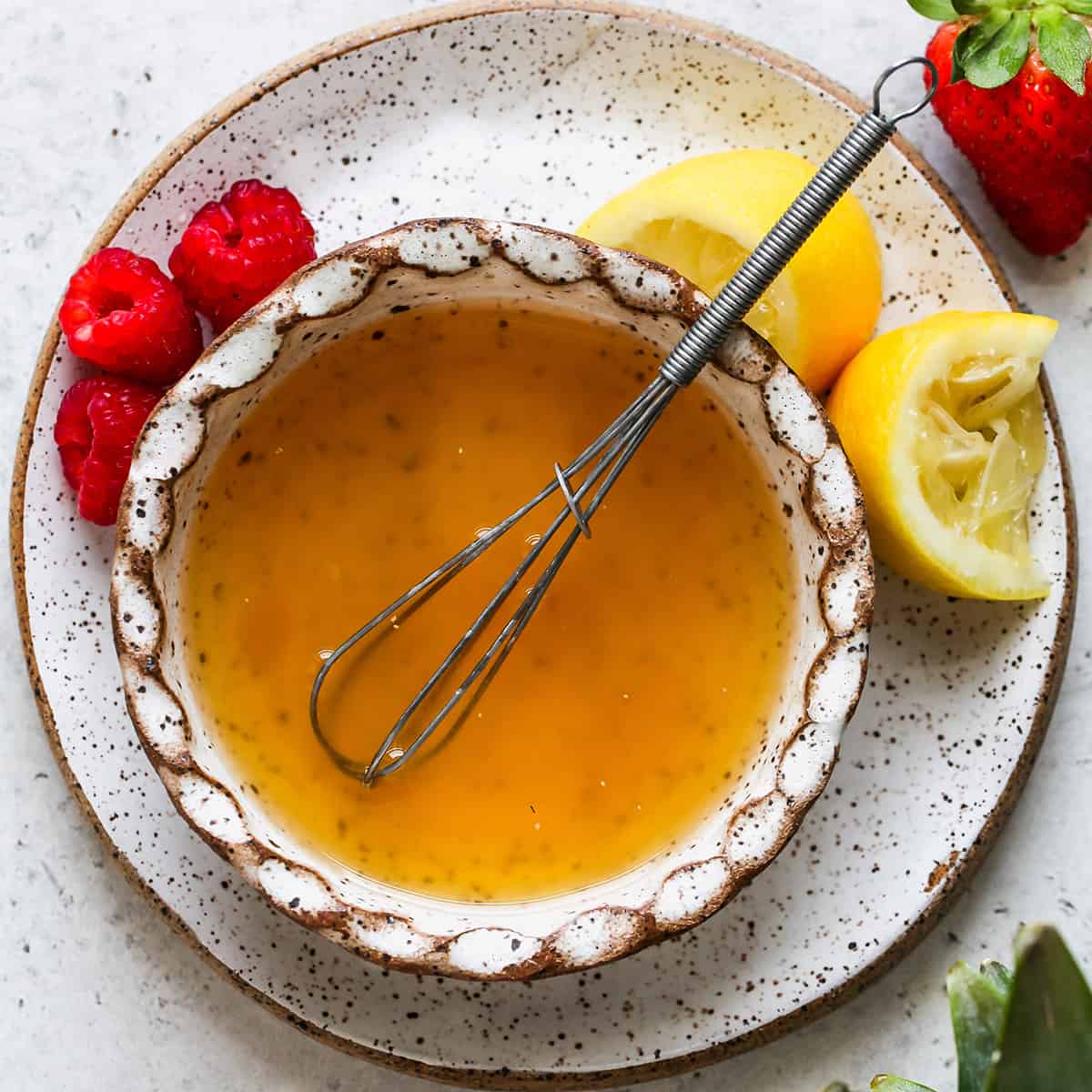 Summer Fruit Salad Dressing in a bowl with a whisk