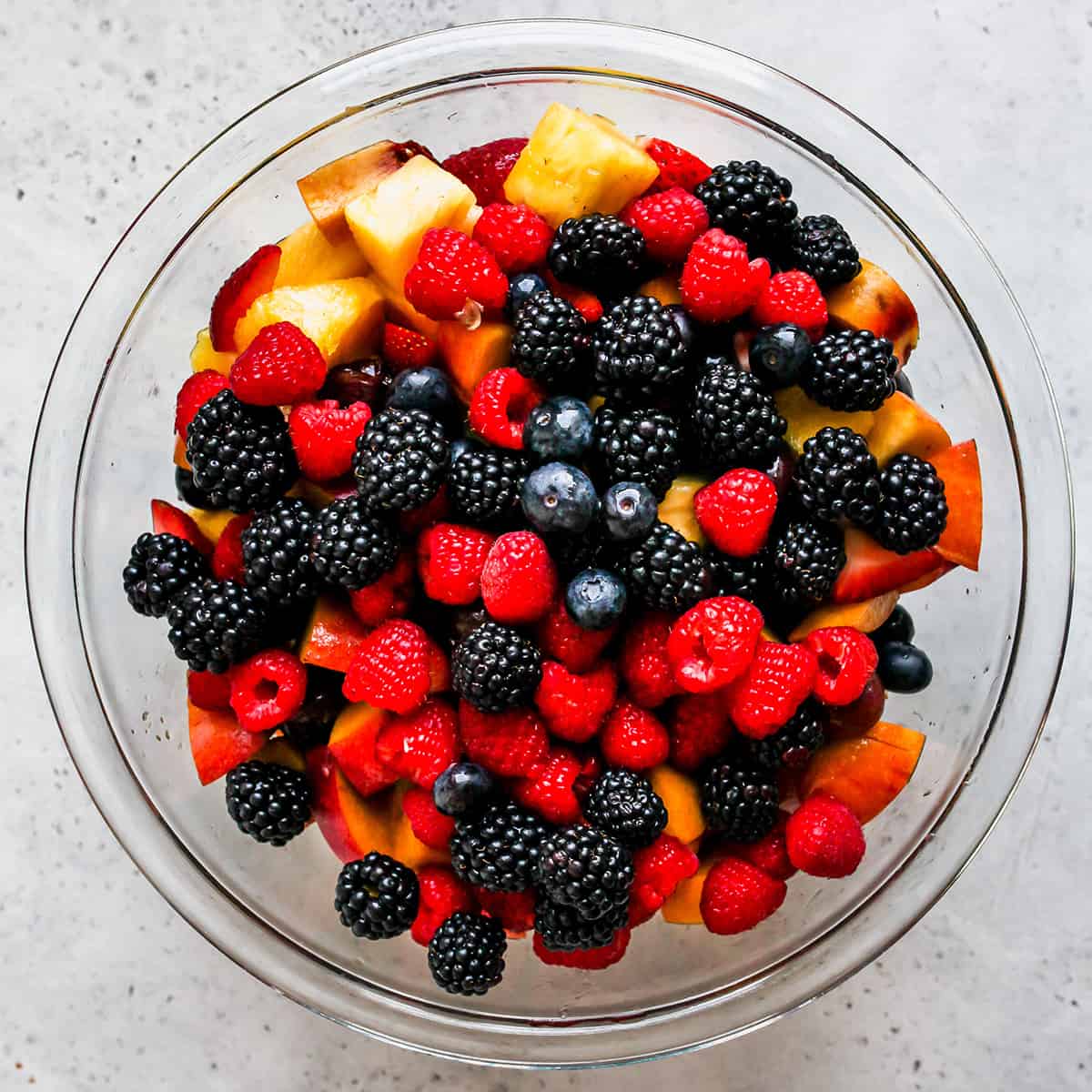 How to Make Fruit Salad - adding berries to the salad.