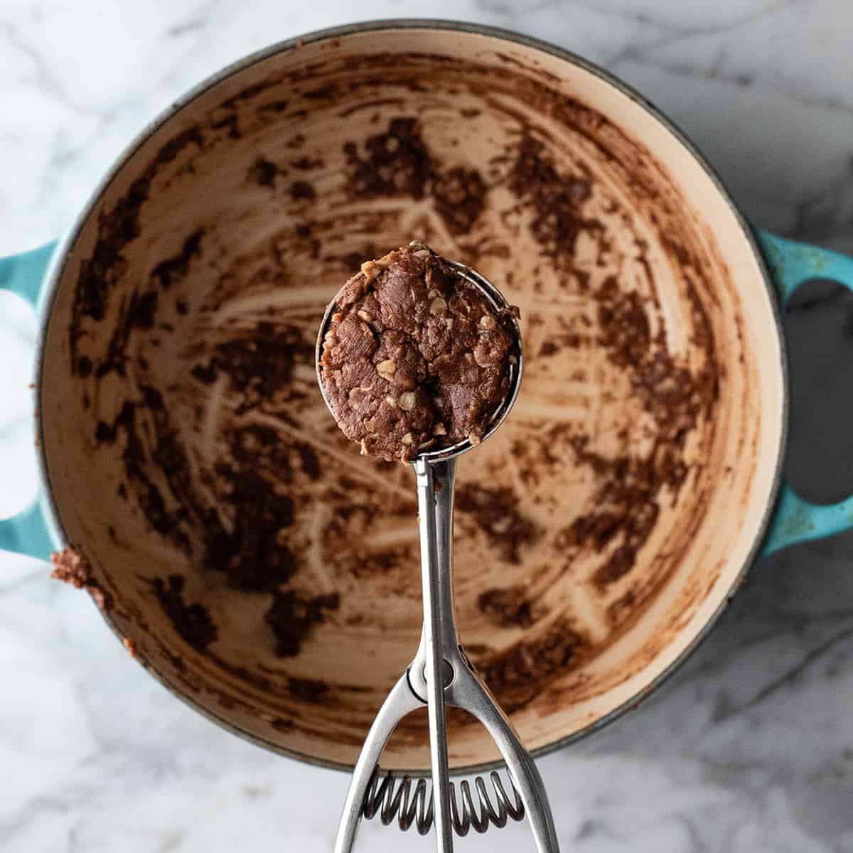 photo showing a cookie scoop portioning out a healthy no bake cookie