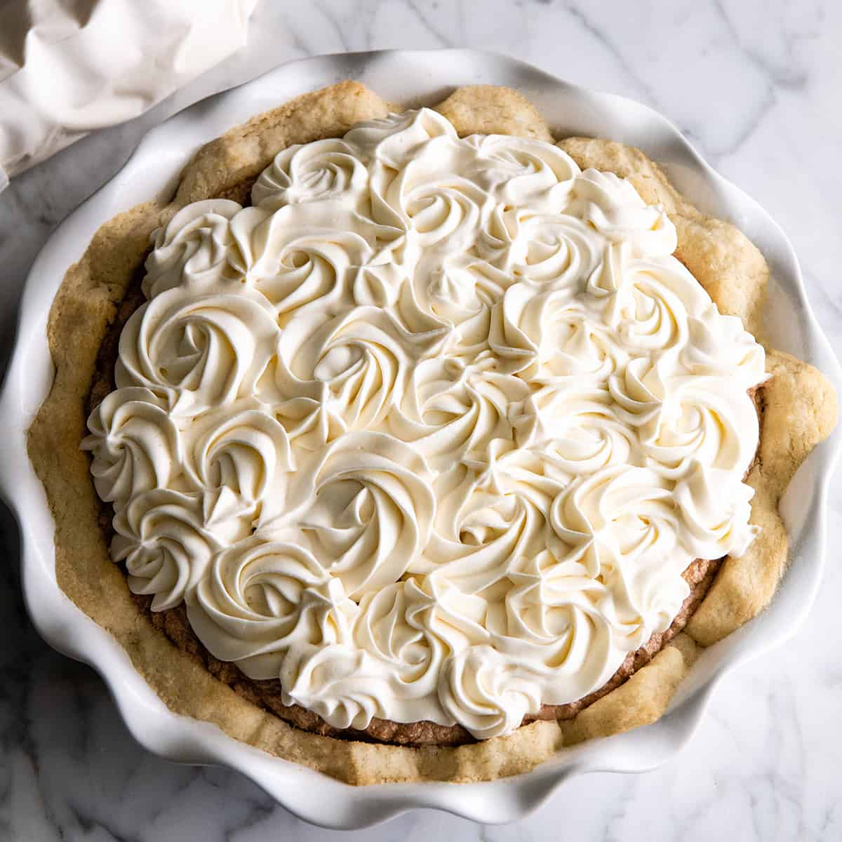 a pie decorated with Homemade Whipped Cream rosettes