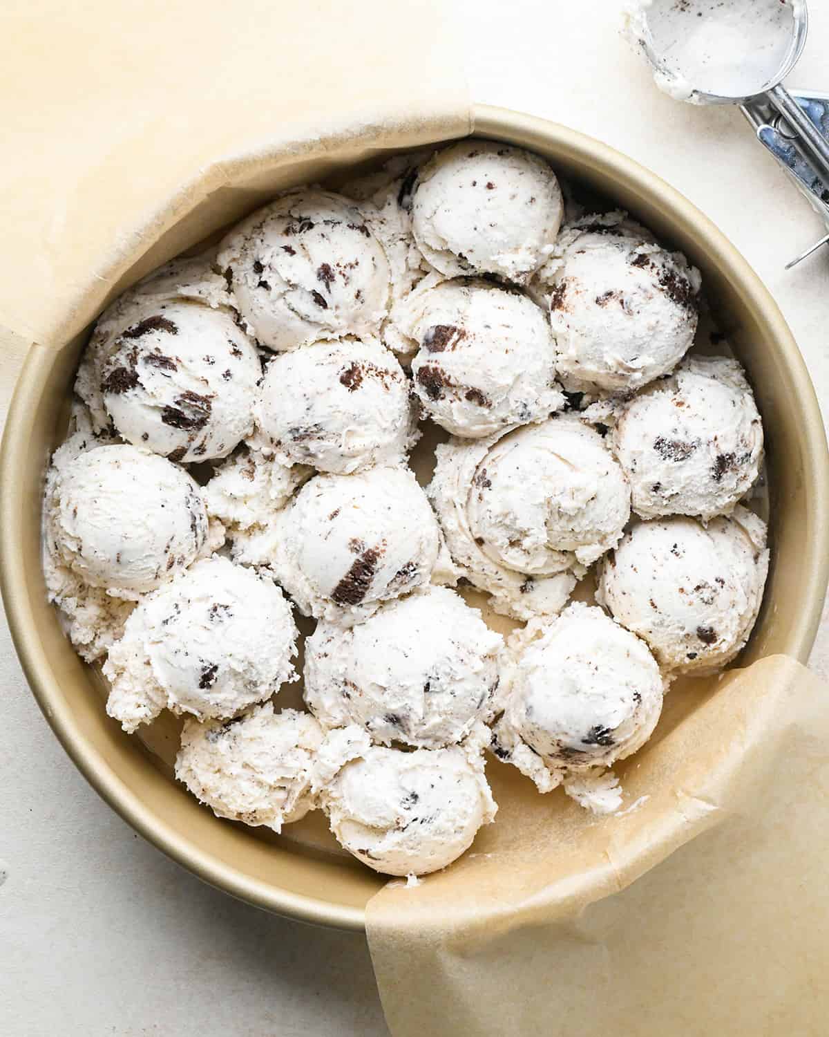 assembling an ice cream cake - ice cream in a cake pan before spreading out
