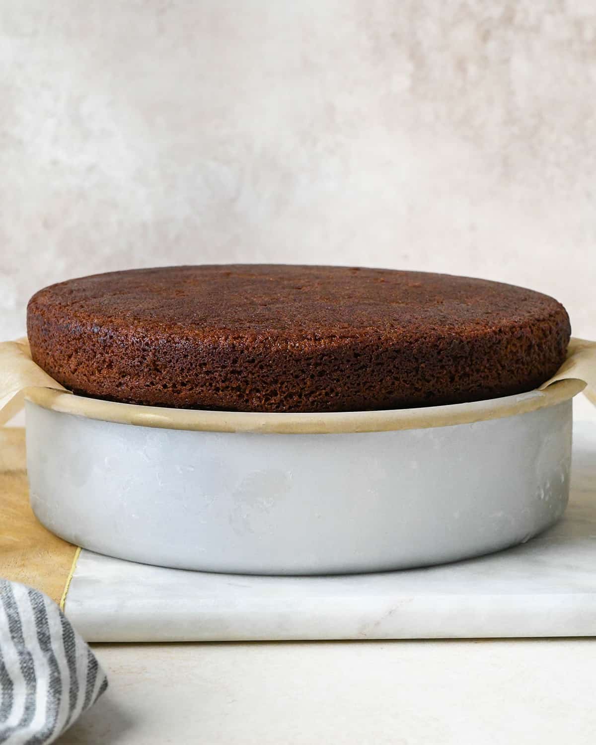 assembling an ice cream cake - baked chocolate cake on top of the other layers