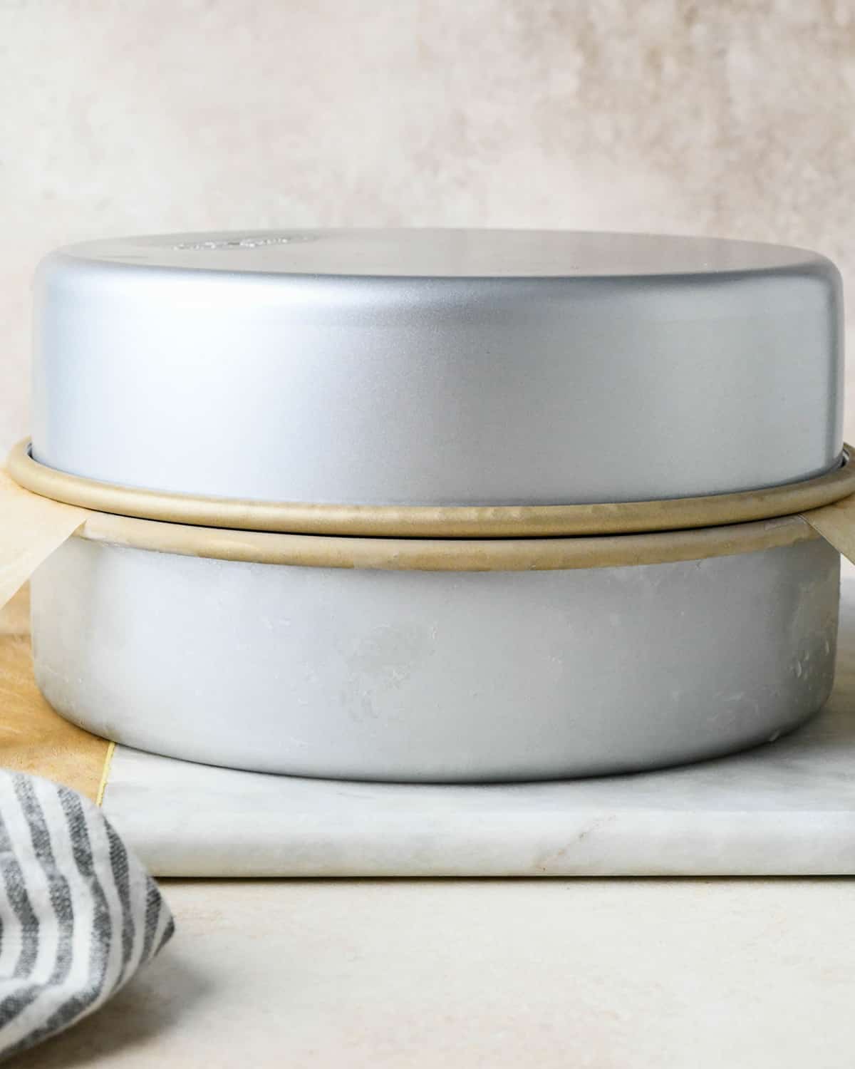 assembling an ice cream cake - two cake pans on top of each other