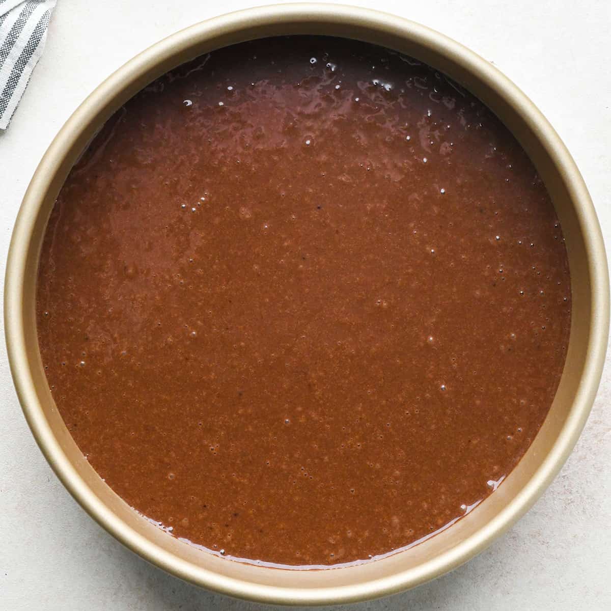 How to Make an Ice Cream Cake - chocolate cake batter in a round baking pan before baking