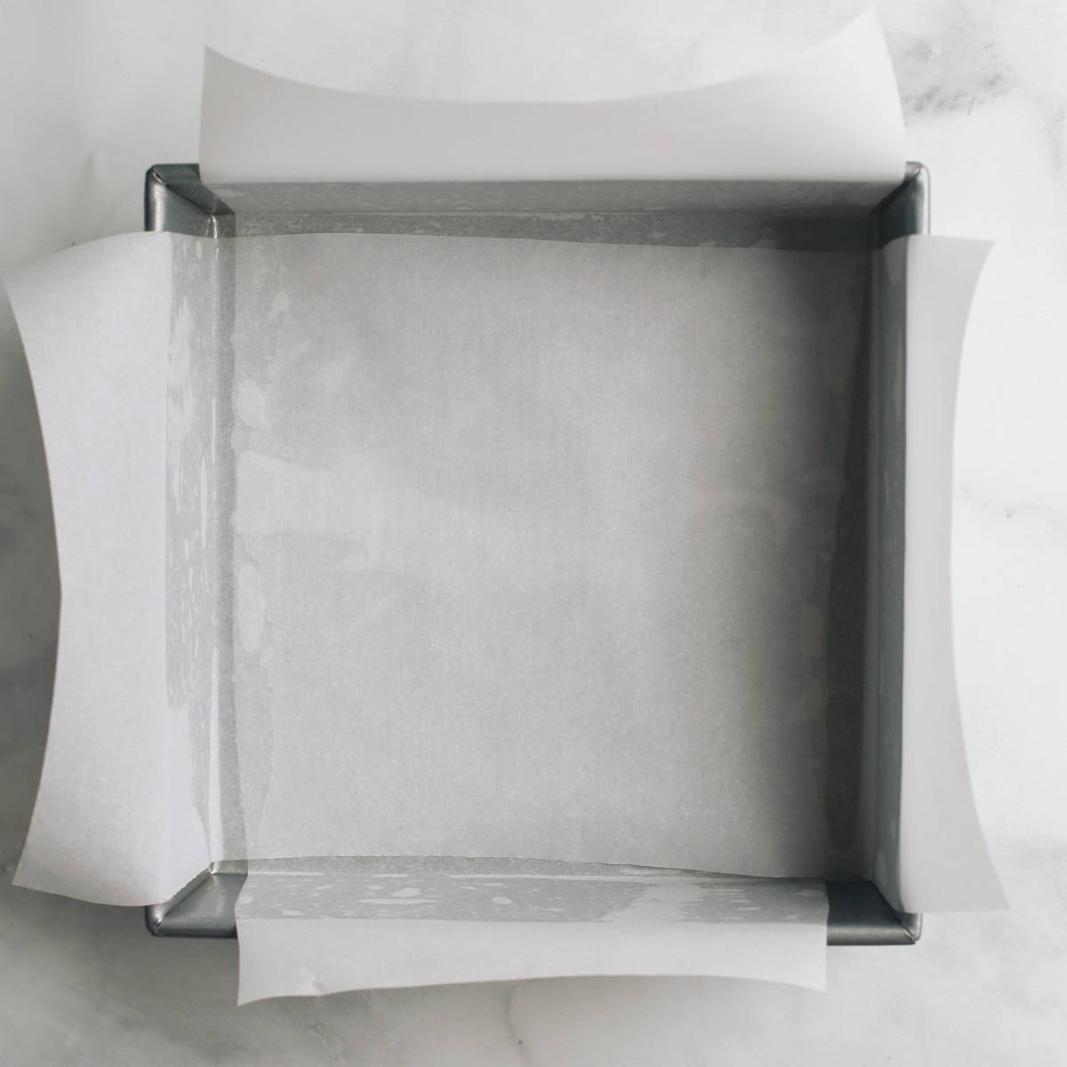 an 8x8" baking dish lined with parchment paper