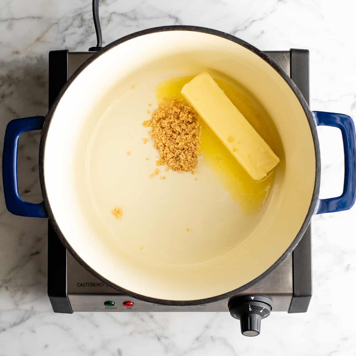 These herb-infused garlic mashed potatoes are the best mashed potatoes you will ever eat. They are creamy, fluffy buttery and so insanely delicious you will never make another mashed potatoes recipe again. Plus they're easy to make and can be prepared ahead of time! photo showing how to make mashed potatoes - cooking butter and garlic