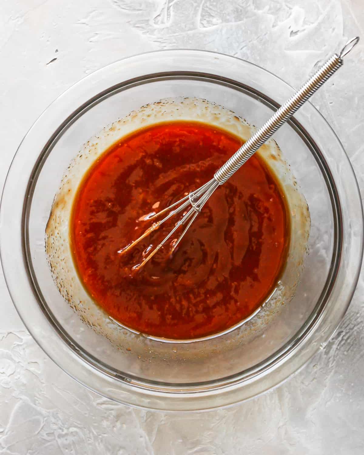 How to Make Meatloaf - glaze ingredients in a bowl with a whisk after mixing