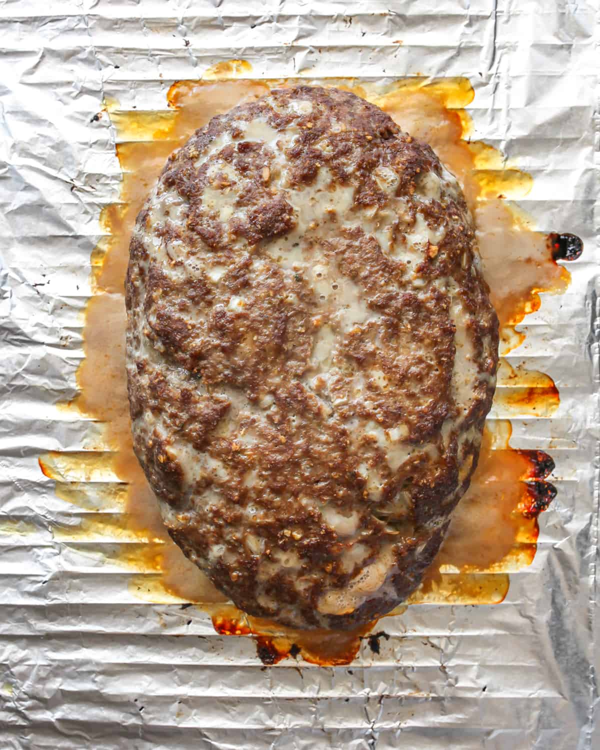 This is the best meatloaf recipe ever! It’s tender, moist and flavorful with the most delicious glaze. This easy meatloaf recipe is a classic that your whole family will love! Watch the video and follow our step-by-step instructions to learn how to make meatloaf! How to Make Meatloaf - meatloaf on a wire rack after baking