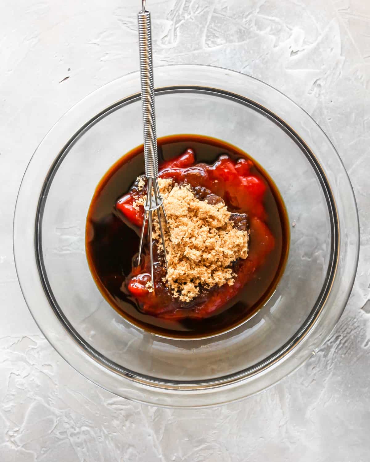 How to Make Meatloaf - glaze ingredients in a bowl with a whisk before mixing