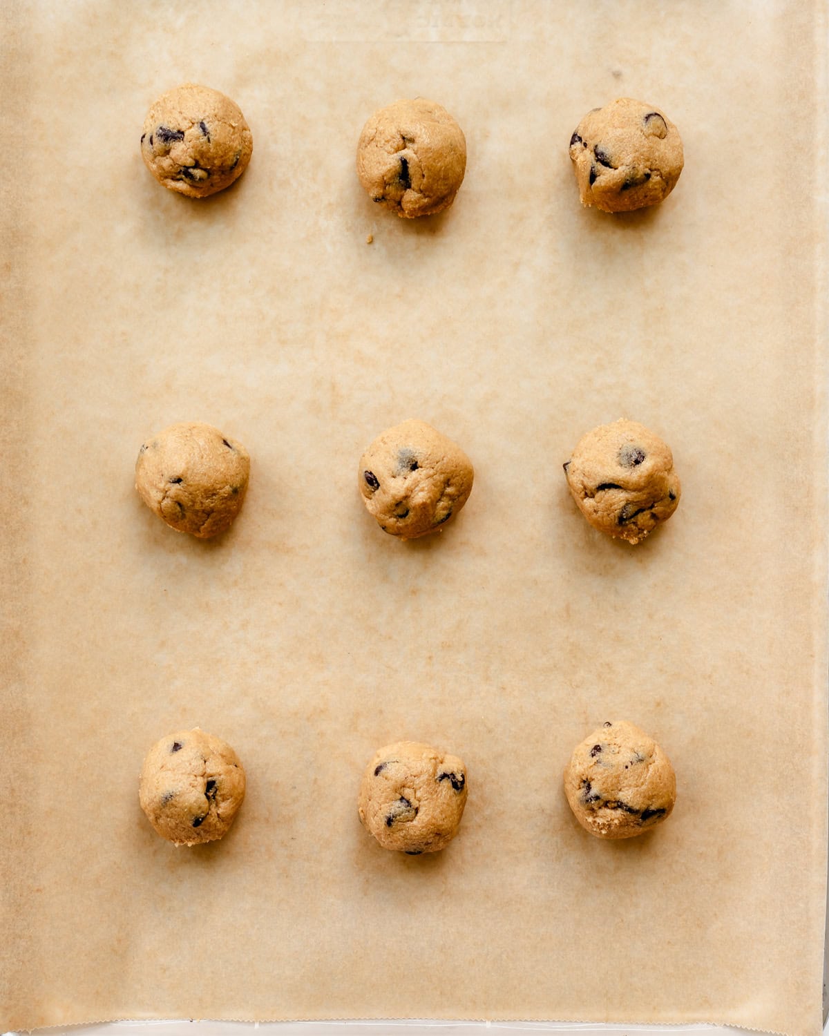 9 oat flour chocolate chip cookies on a baking sheet before baking