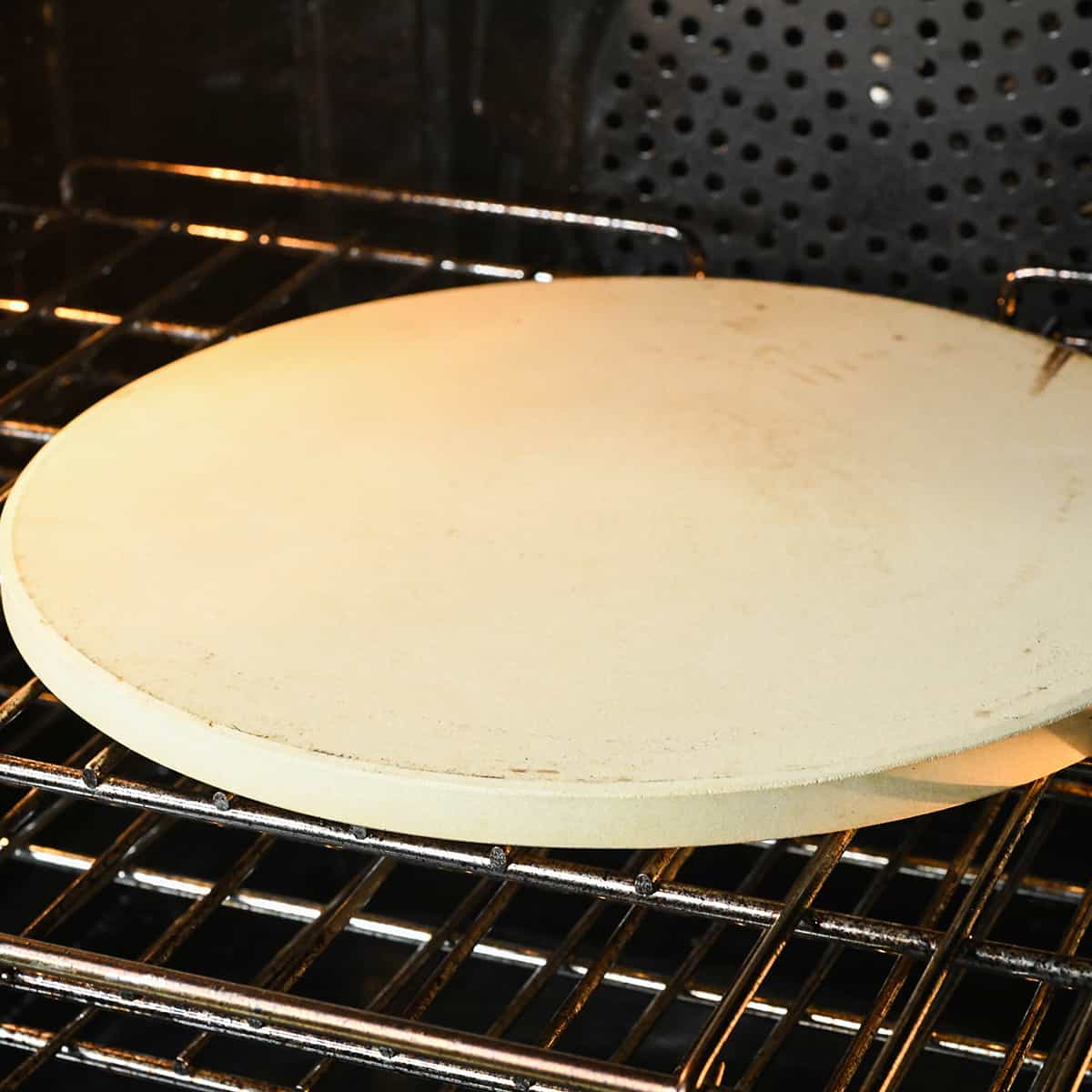 a pizza stone in an oven preheating to make pizza dough