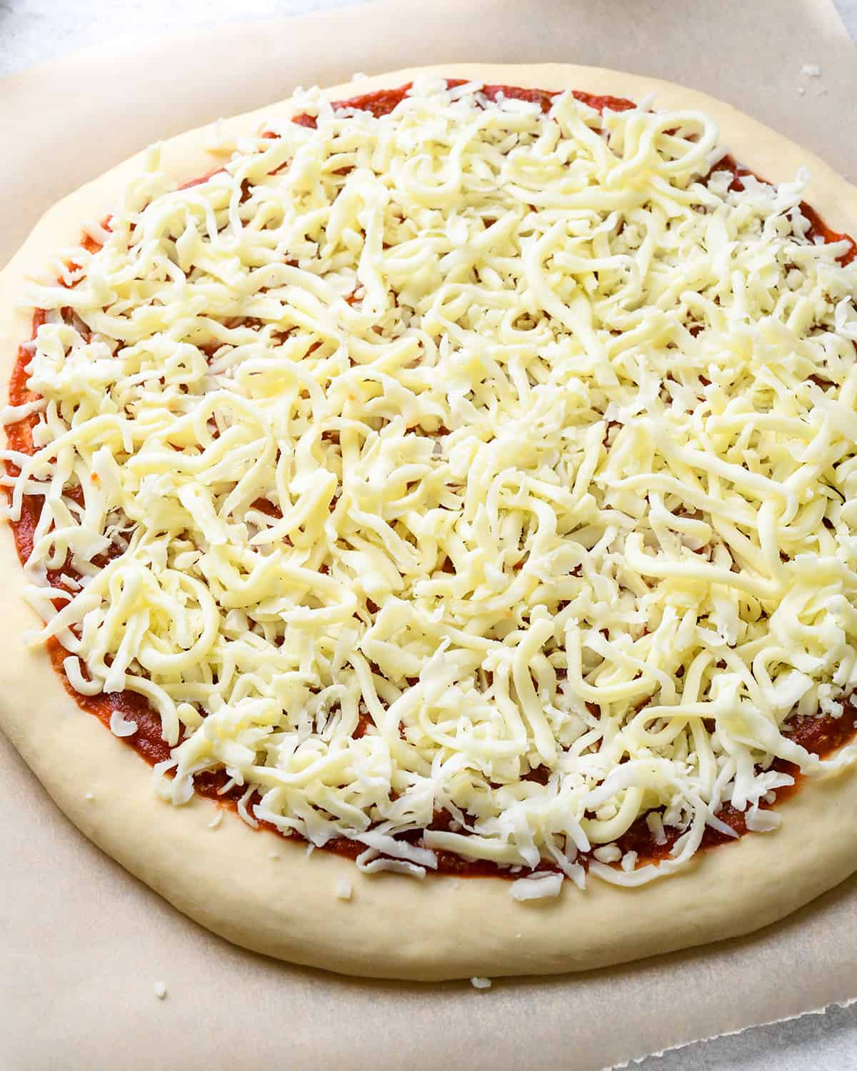 How to Make Pizza cheese on the sauce
