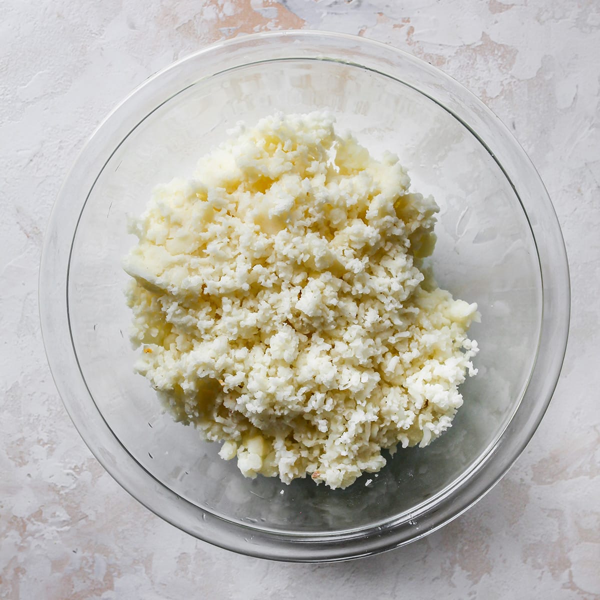 How To Make Potato Pancakes - potatoes riced into a bowl