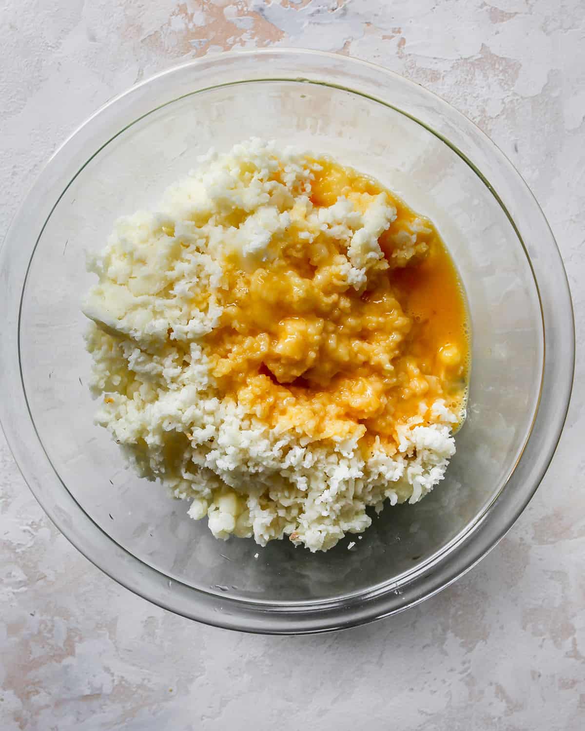 How To Make Potato Pancakes - adding wet ingredients to riced potatoes before mixing