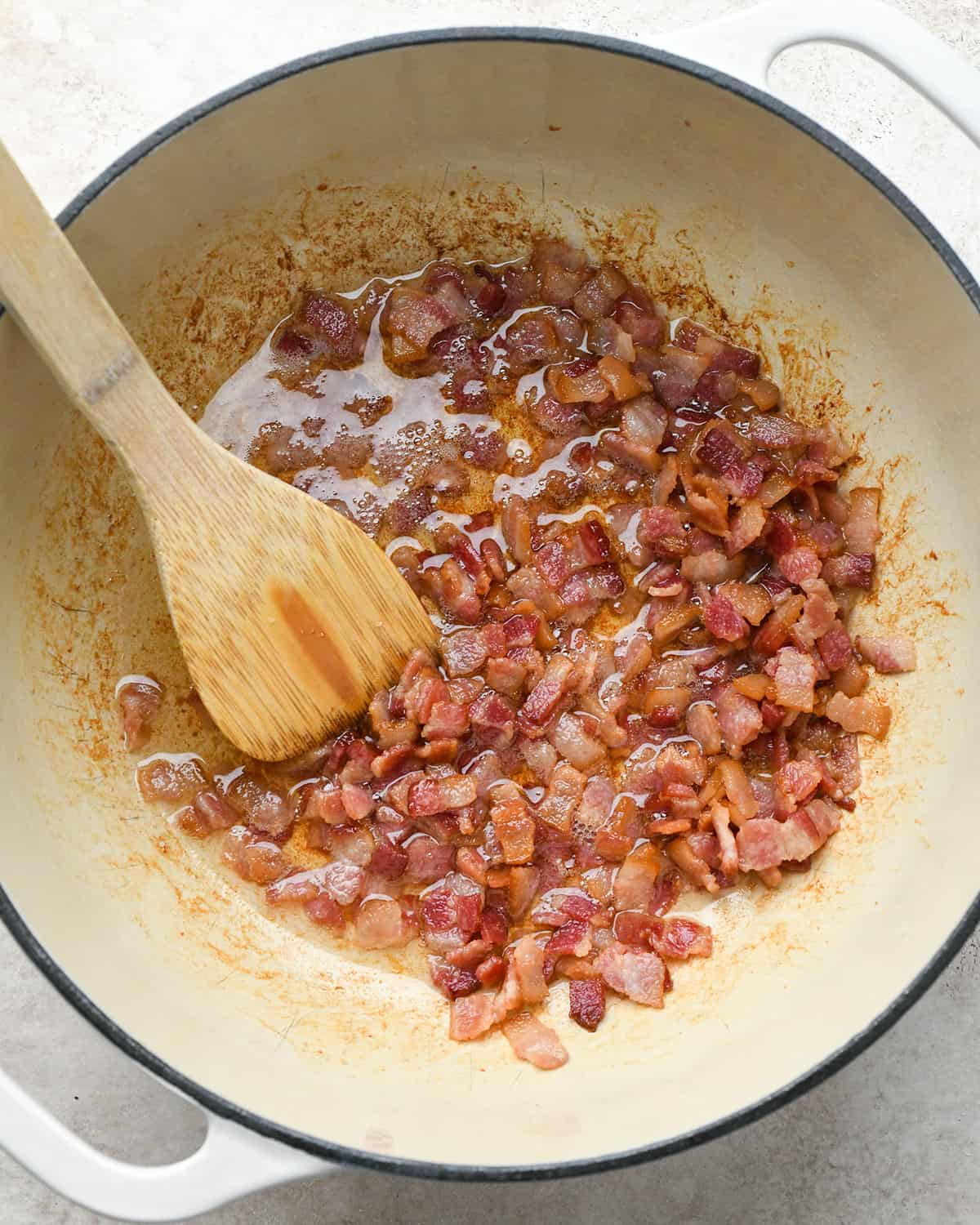 cooking bacon in a dutch oven to make potato soup.