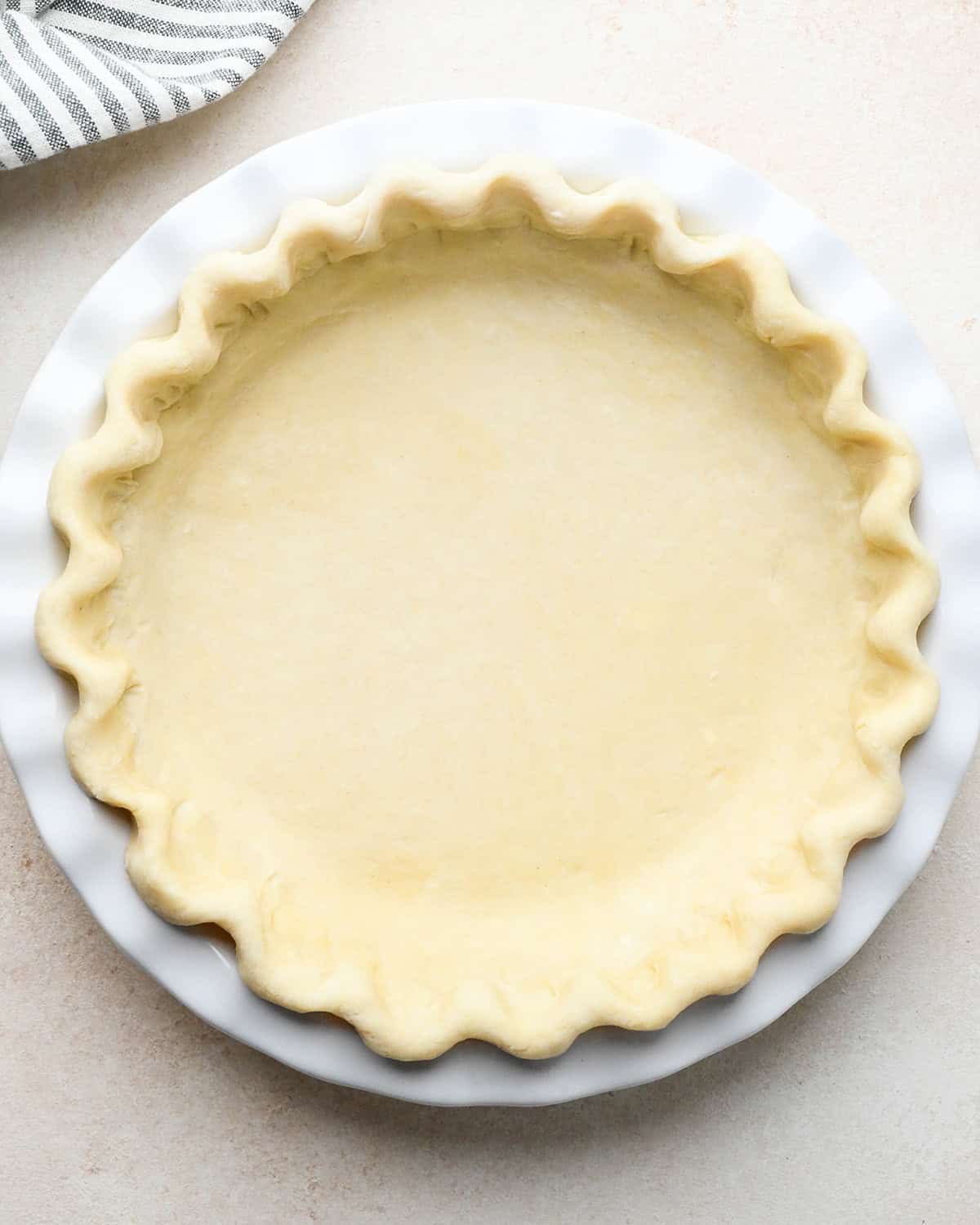 unbaked quiche crust in a pie dish