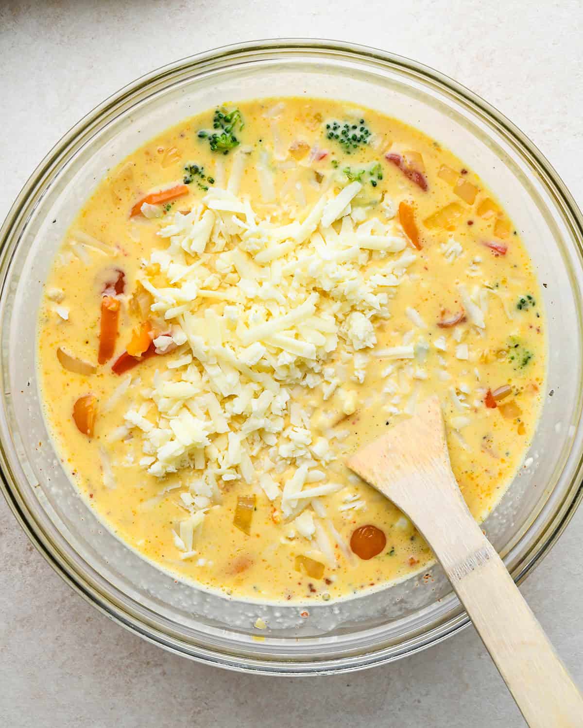 how to make quiche -adding cheese and vegetables before stirring