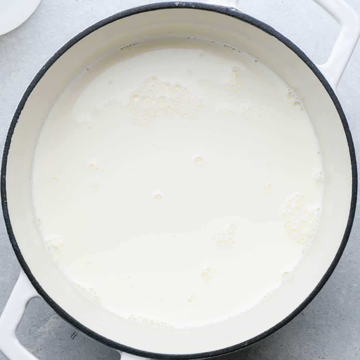 How to Make Strawberry Ice Cream - warming half and half and sugar in a pan