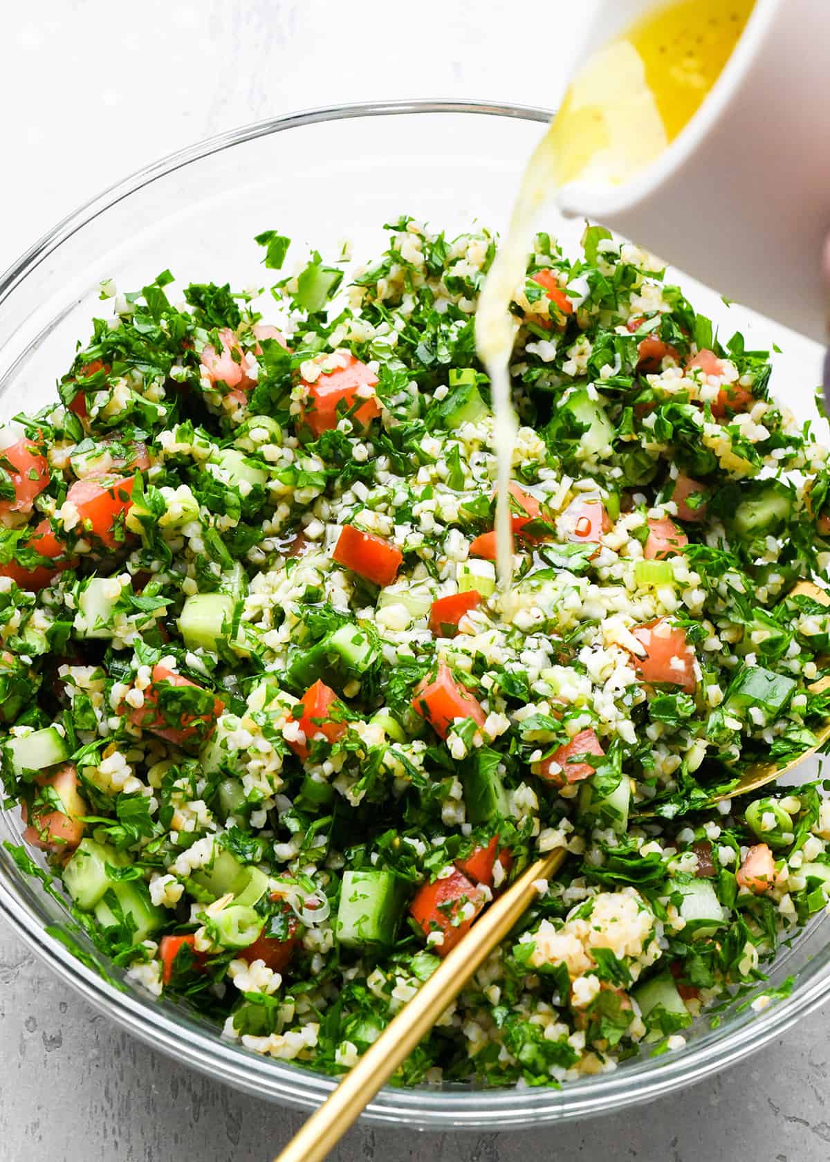How to Make Tabouli - pouring dressing over the tabouli