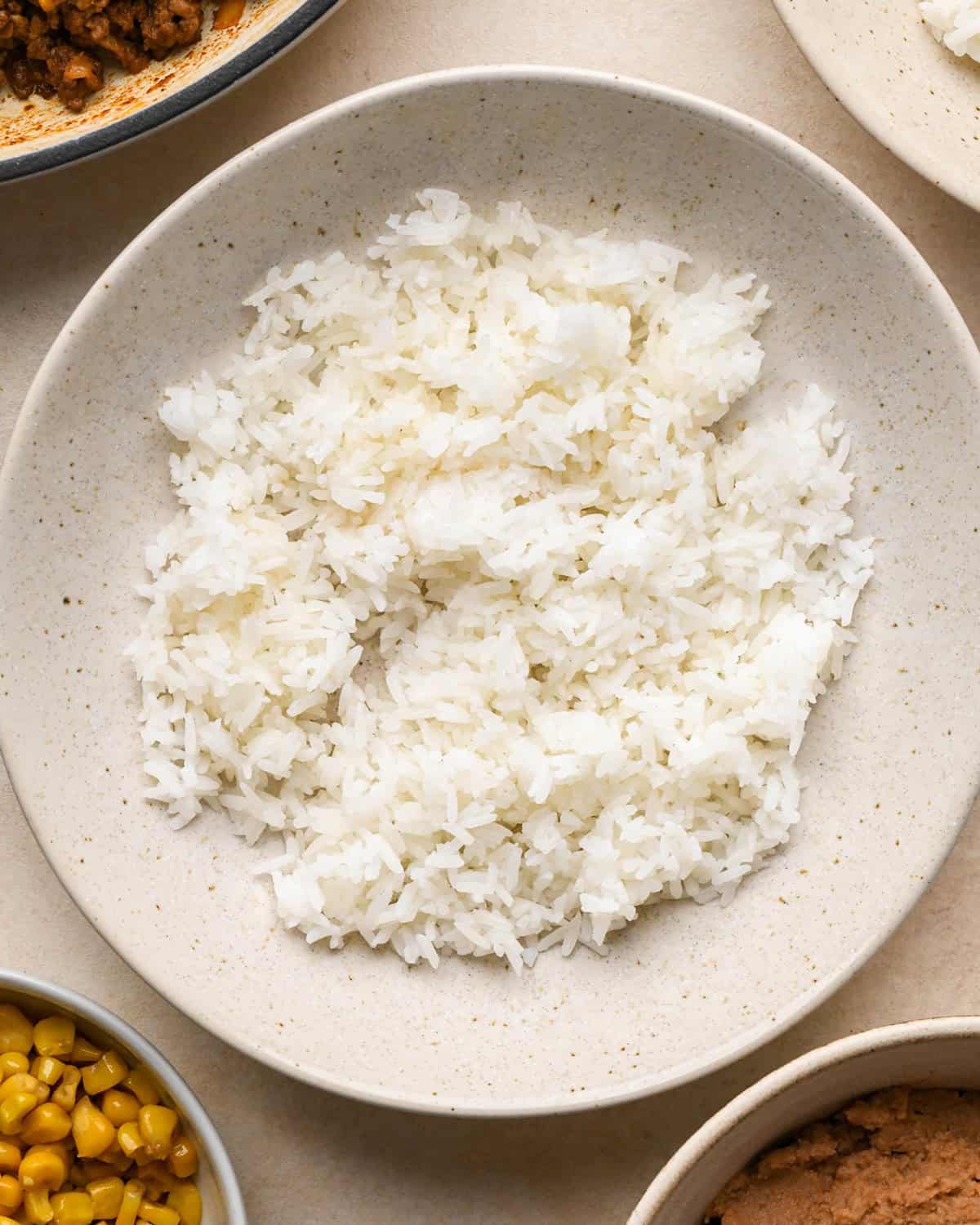 Assembling taco bowls - rice in a bowl