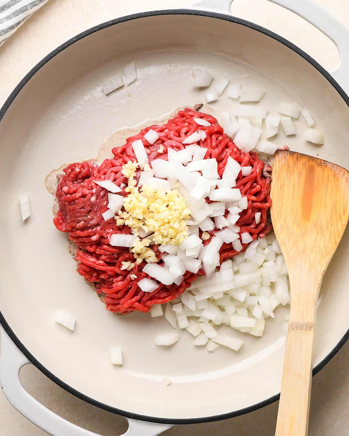 Recipe for Taco Bowls - ground beef, onion and garlic in a pan before cooking