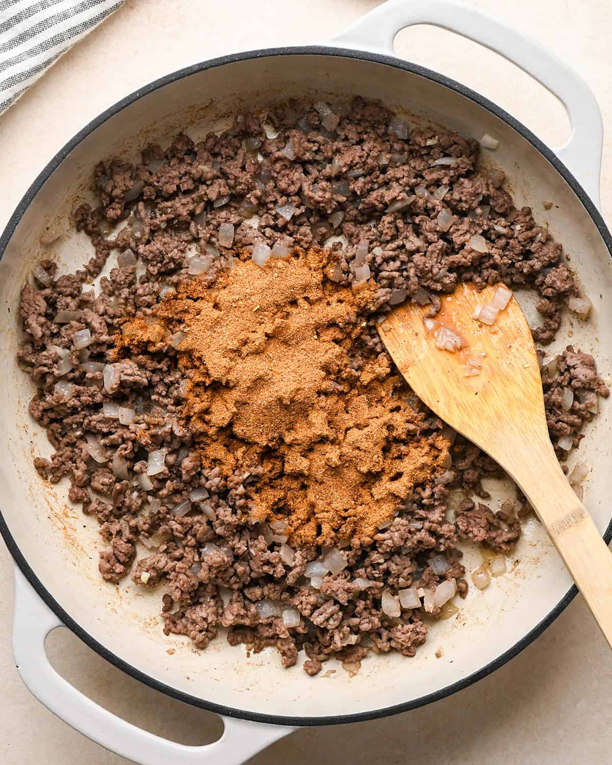 Recipe for Taco Bowls - adding taco seasoning to ground beef