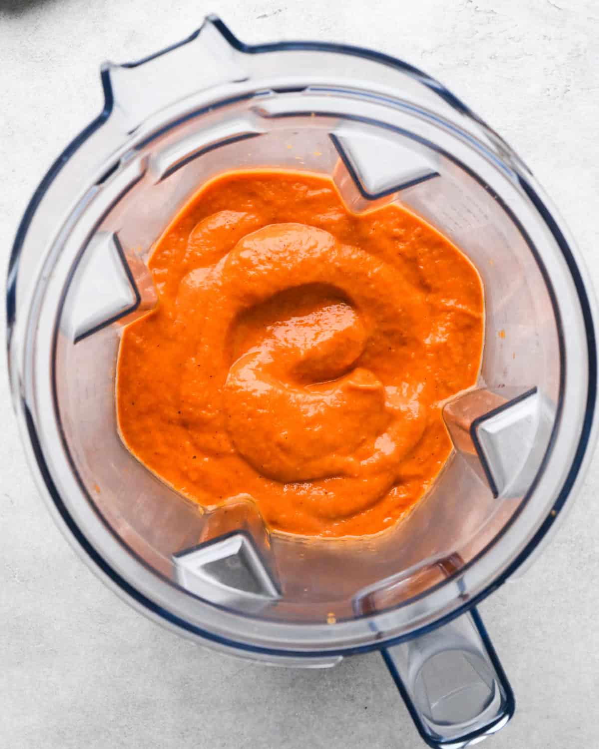 tomato puree after blending in a container of a blender