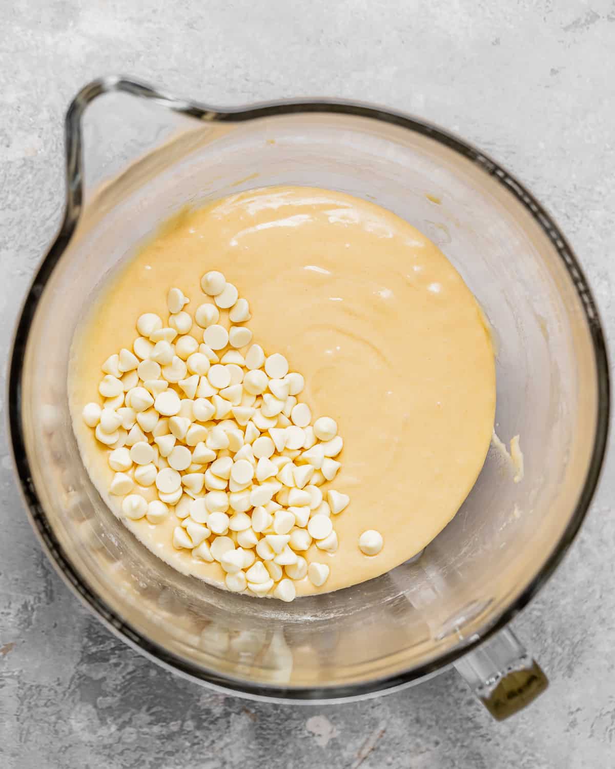 how to make White Chocolate Brownies - white chocolate chips added to the batter in a bowl