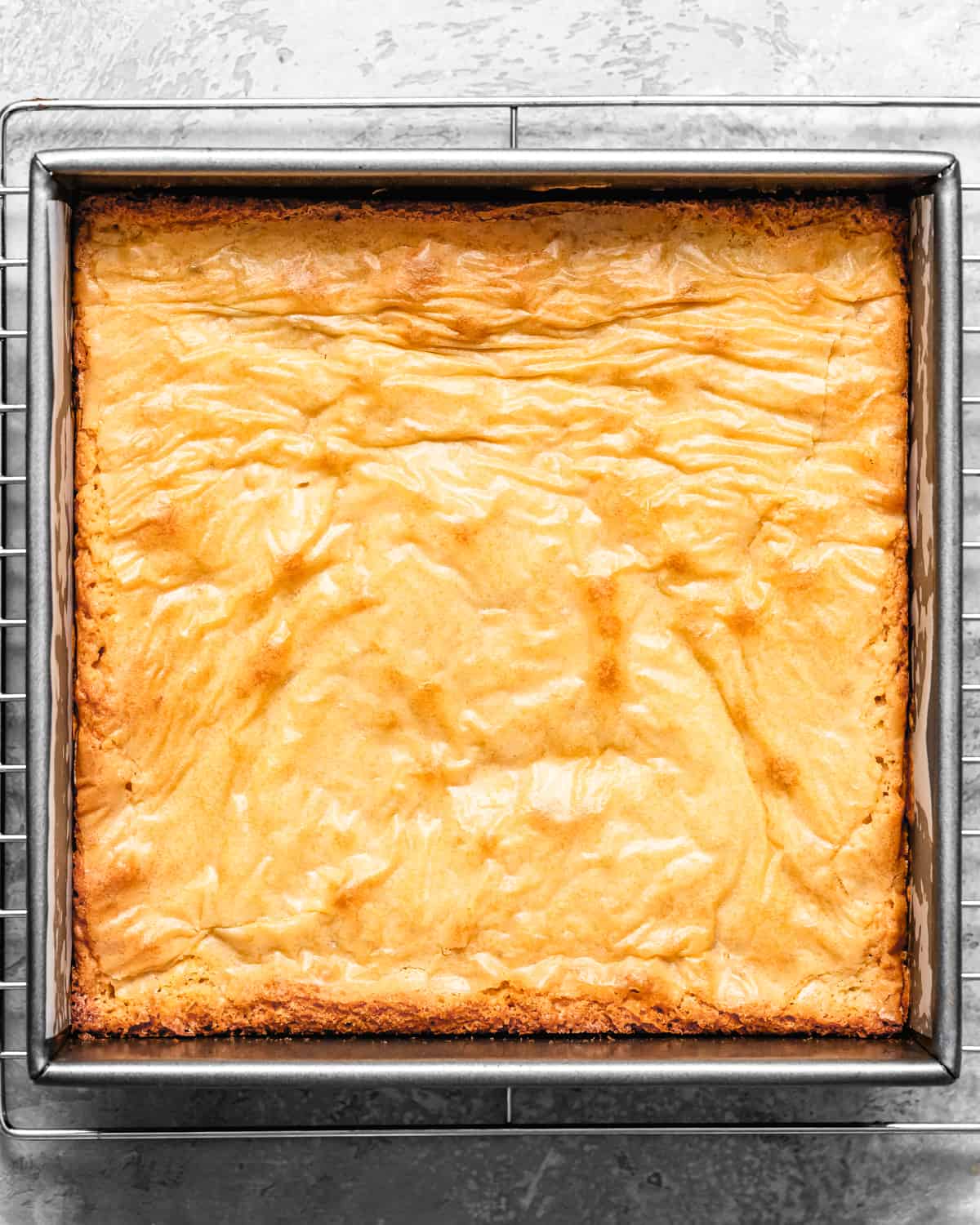 White Chocolate Brownies in a baking pan on a cooling rack after baking