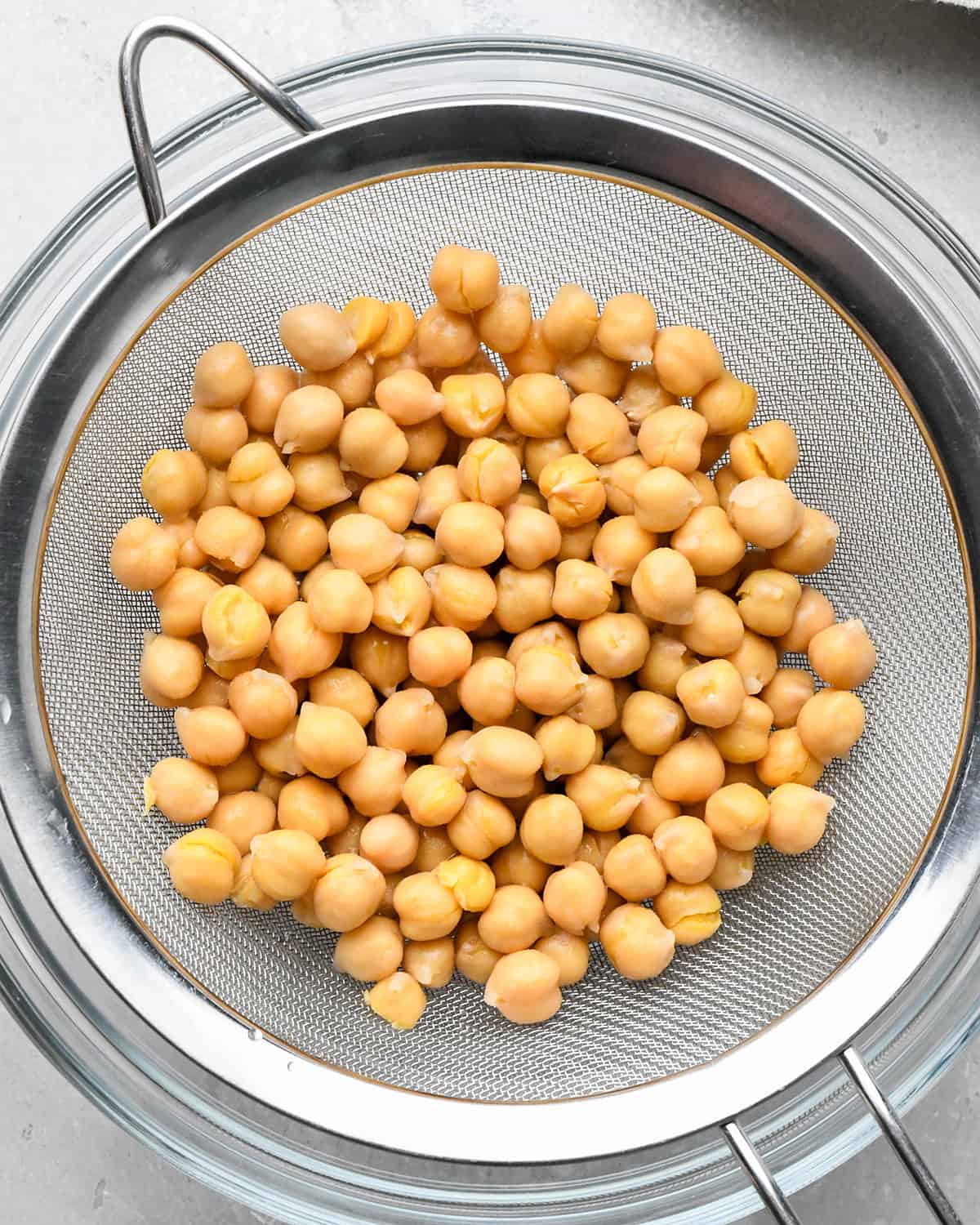 How to Roast Chickpeas - draining chickpeas in a metal sieve.