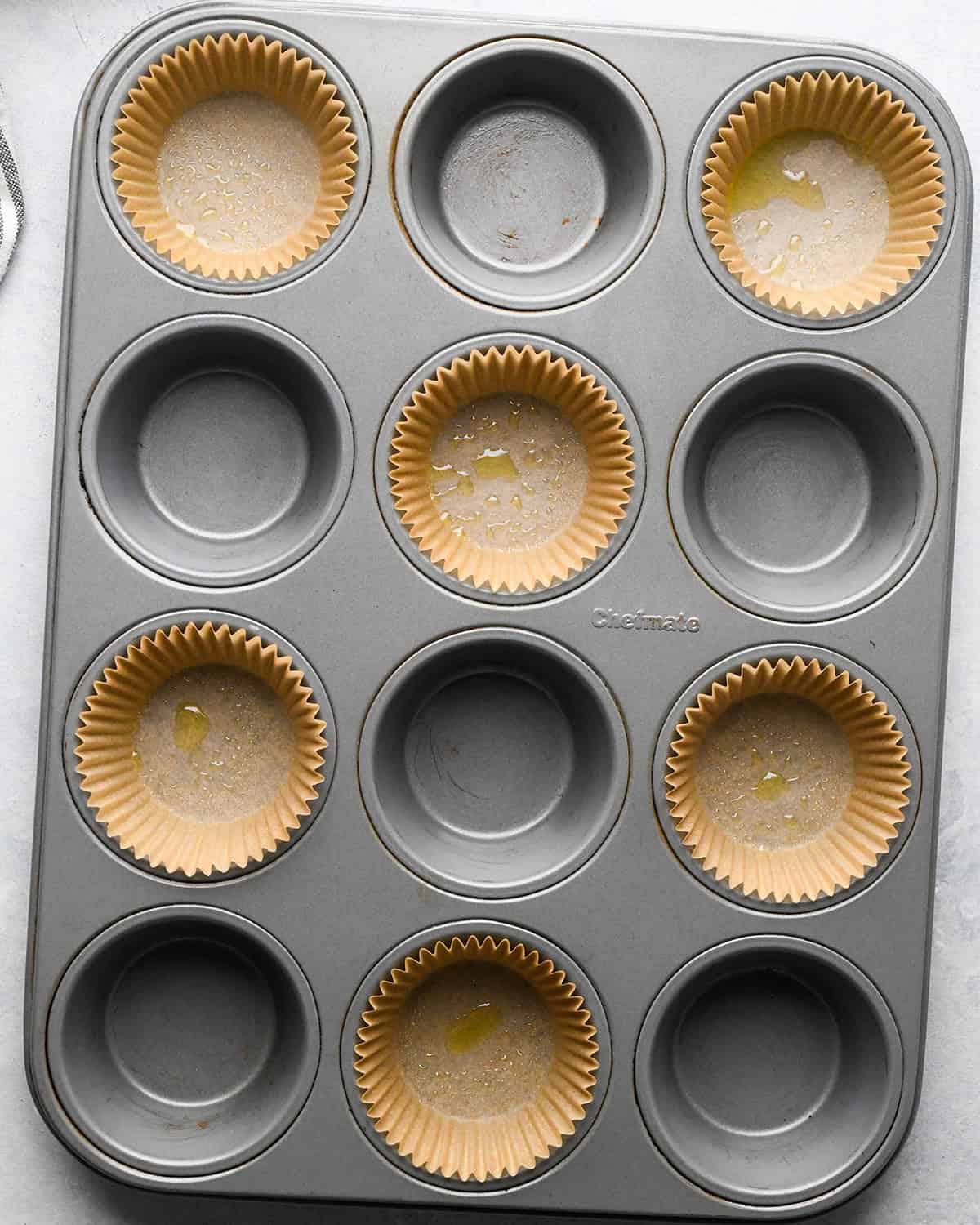 a muffin pan lined with 6 muffin liners