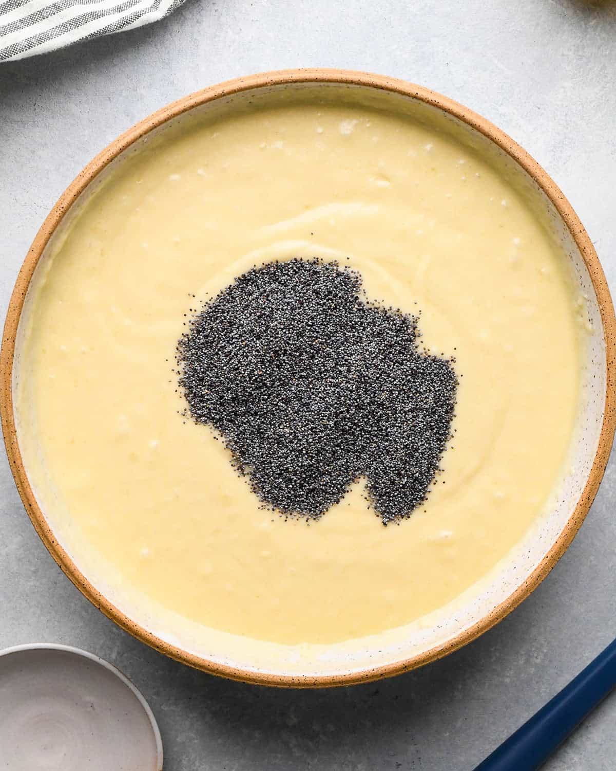 how to make Lemon Poppy Seed Muffins - poppy seeds added to batter before stirring