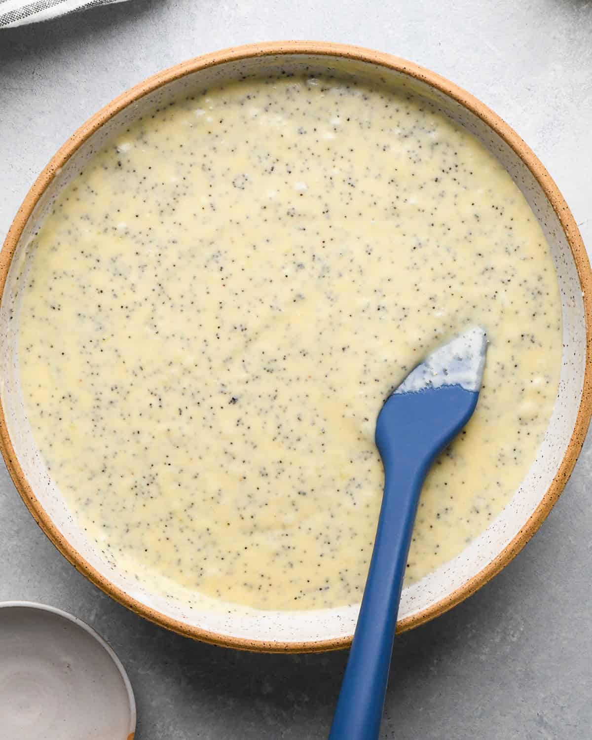 Lemon Poppy Seed Muffins batter in a bowl with a spatula